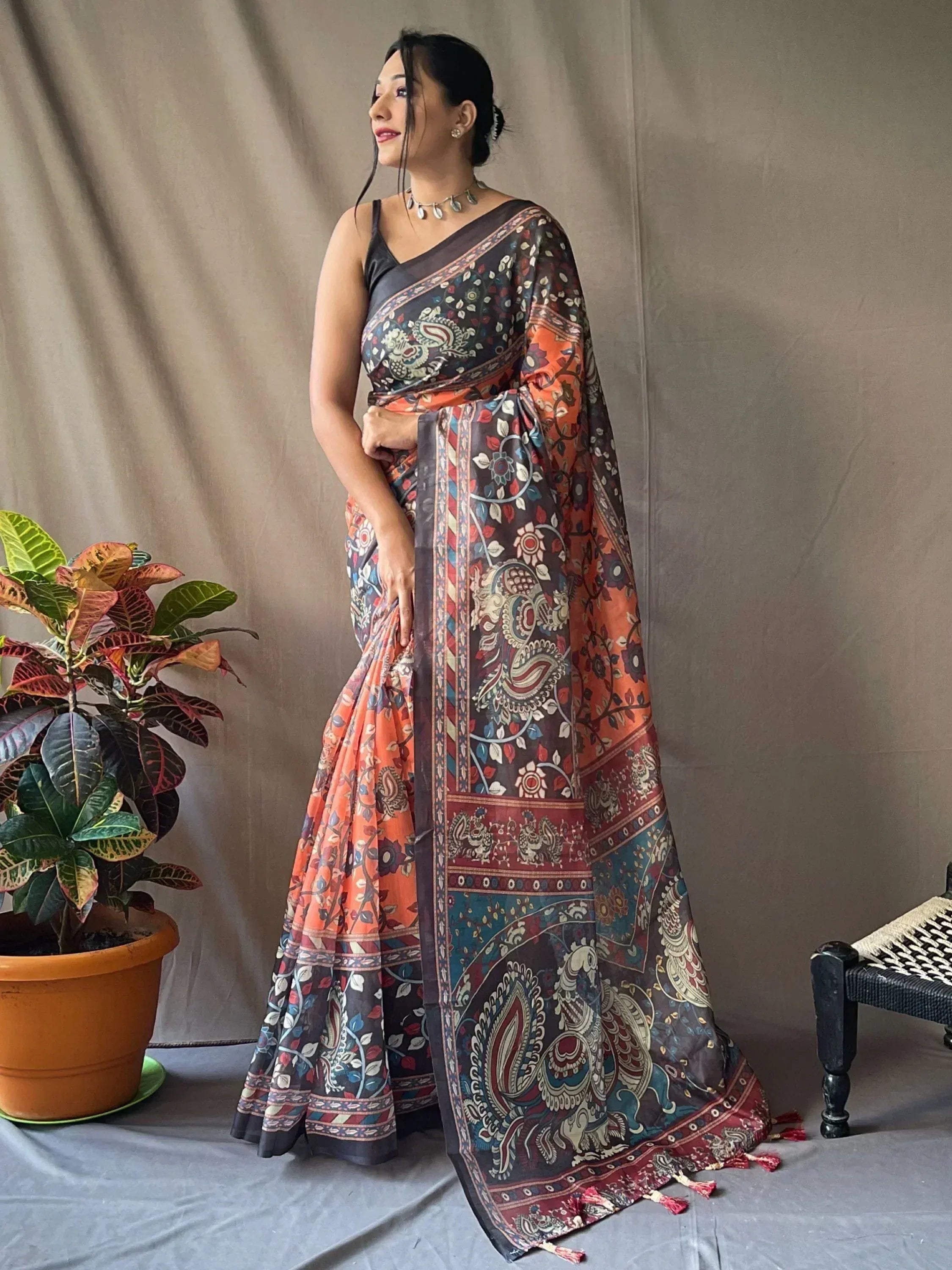 Woman in vibrant printed ethnic saree with paisley design, perfect for Indian occasions