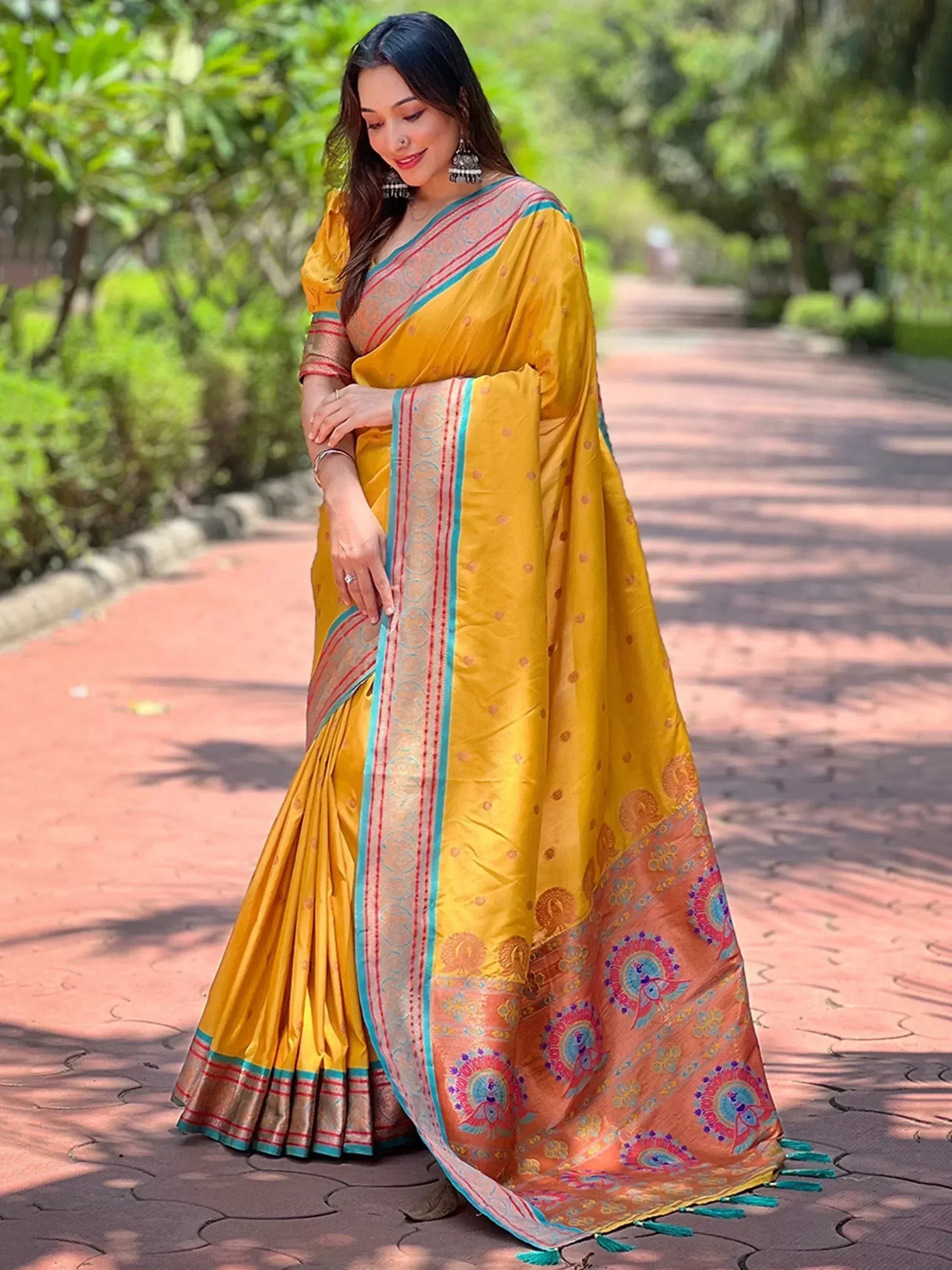 Yellow designer saree with peacock motifs and contrast border, perfect for ethnic occasions