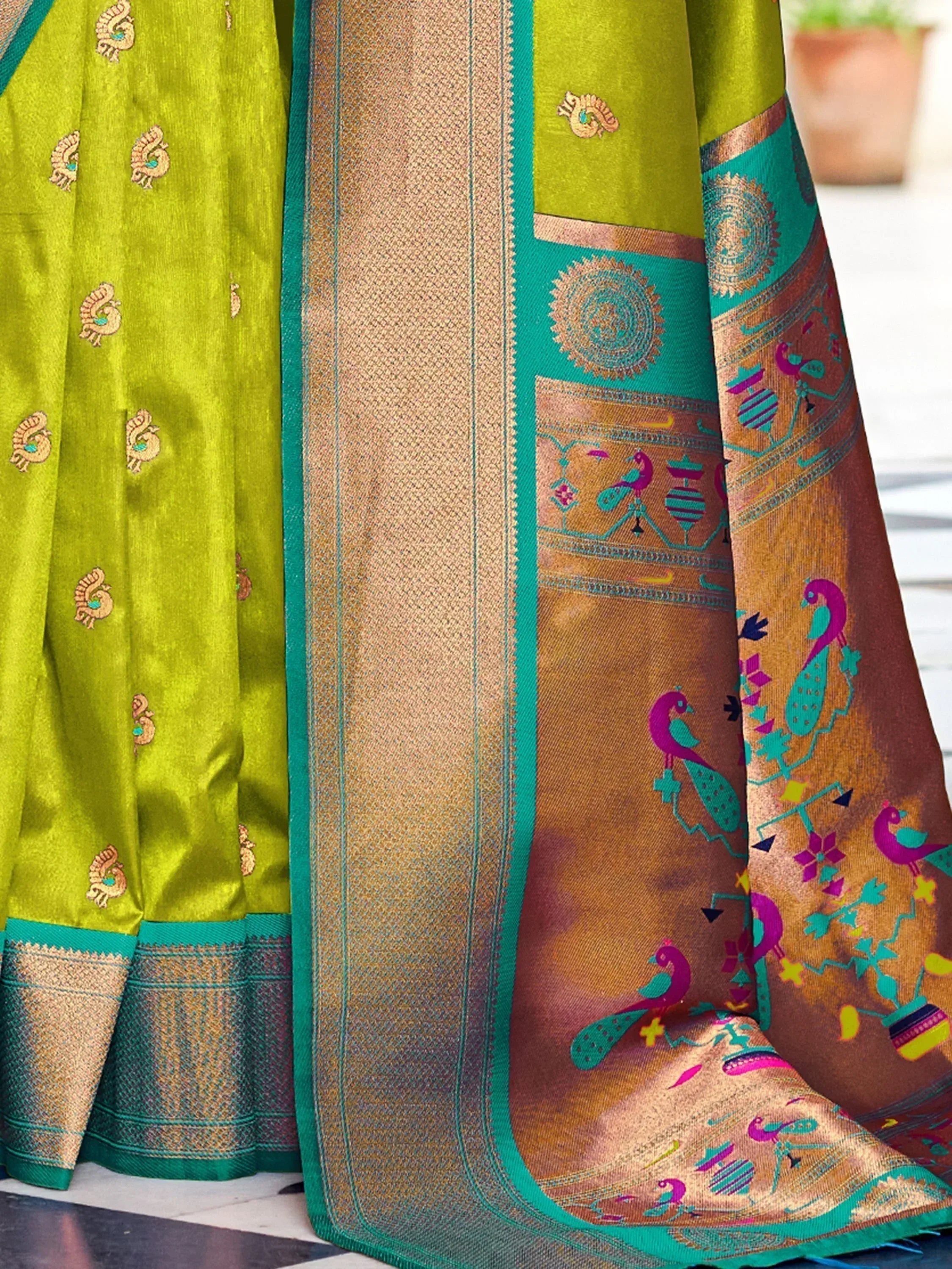 Vibrant green saree with peacock motifs and intricate gold border, perfect for Indian ethnic wear