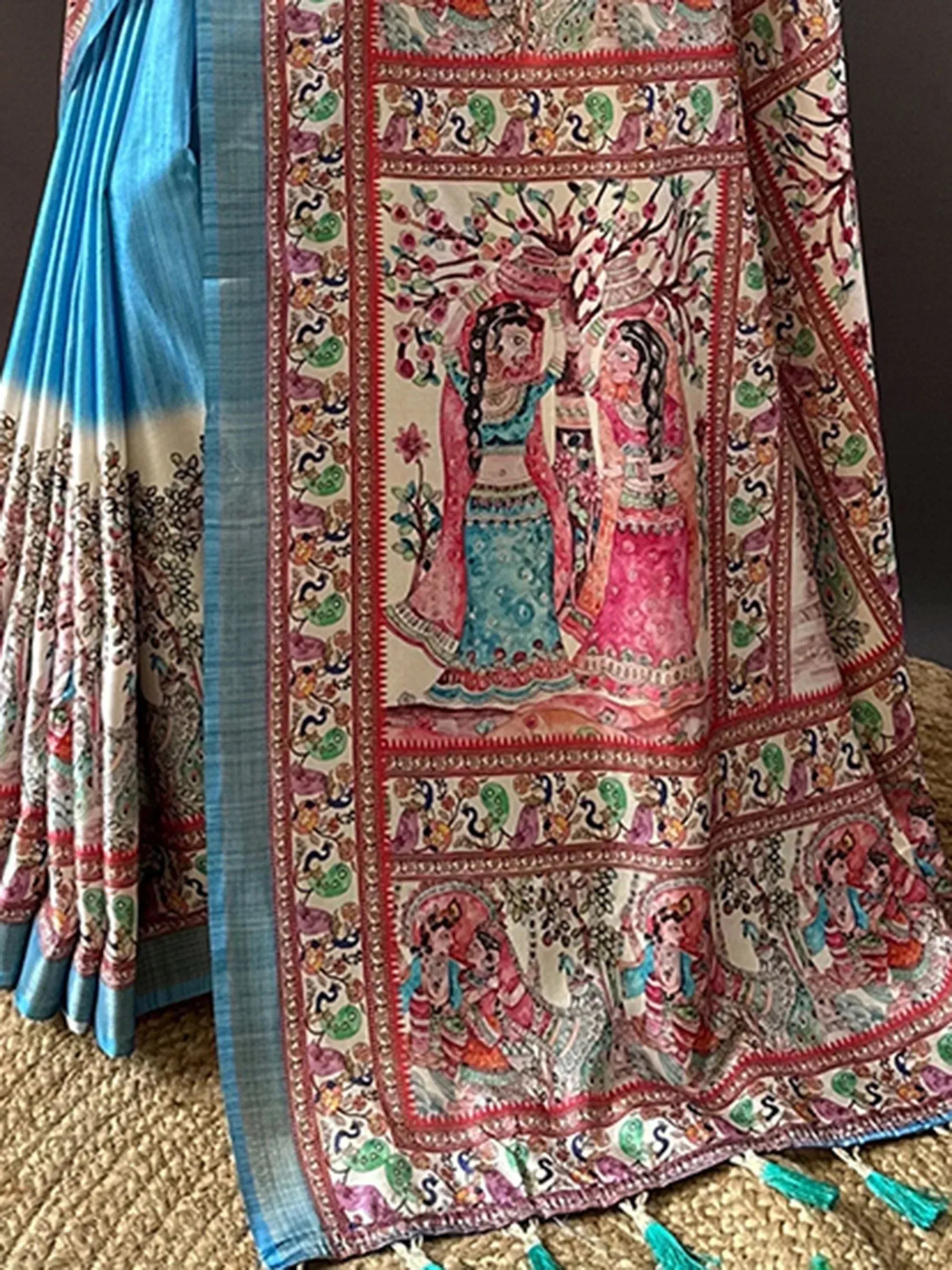 Blue and cream saree with intricate hand-painted Indian motifs and tassels, perfect for ethnic occasions.
