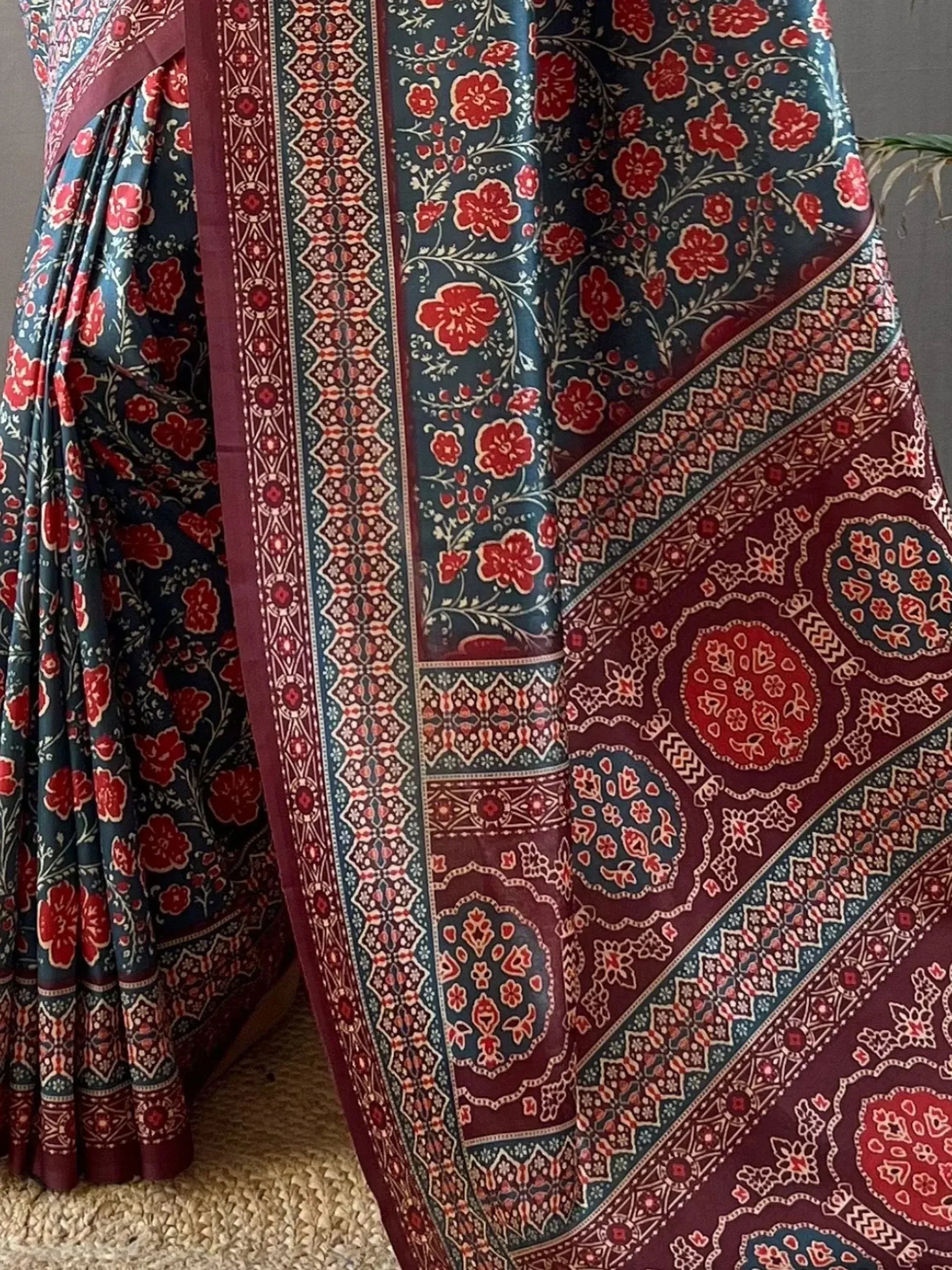 Indian floral saree with red and teal print, intricate border design, ethnic wear