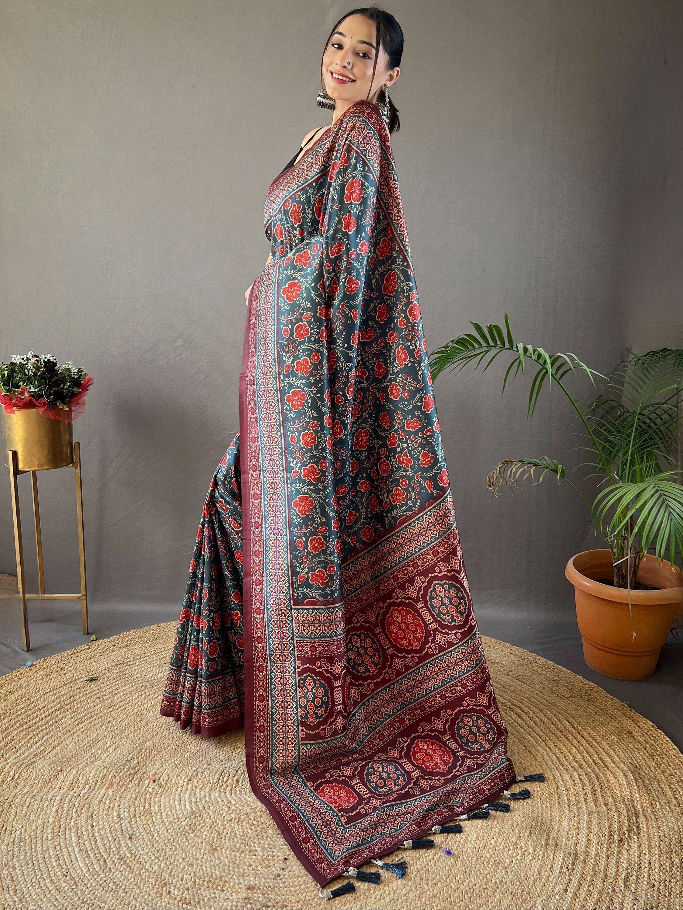 Woman wearing floral print Indian saree with red and blue patterns, ethnic wear for festive occasions
