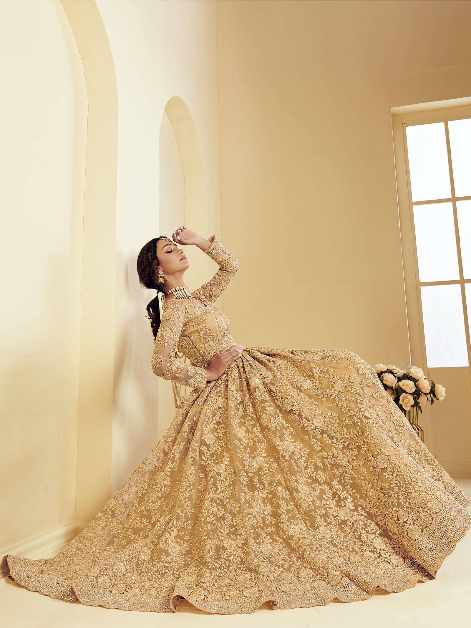Elegant gold embroidered lehenga choli with floral detailing, perfect for Indian weddings and festive occasions.
