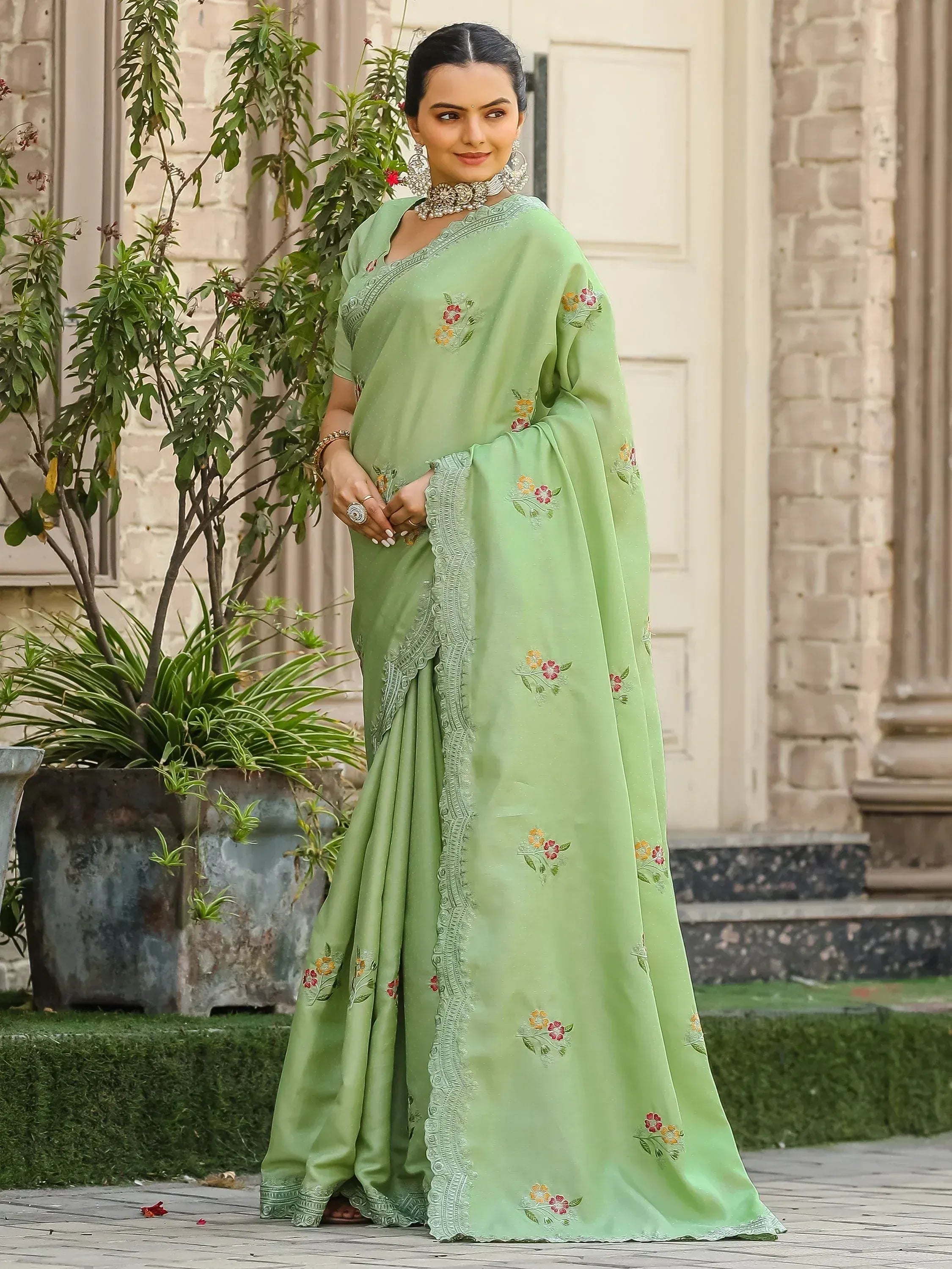 Light green embroidered saree with floral motifs, perfect for Indian ethnic wear occasions