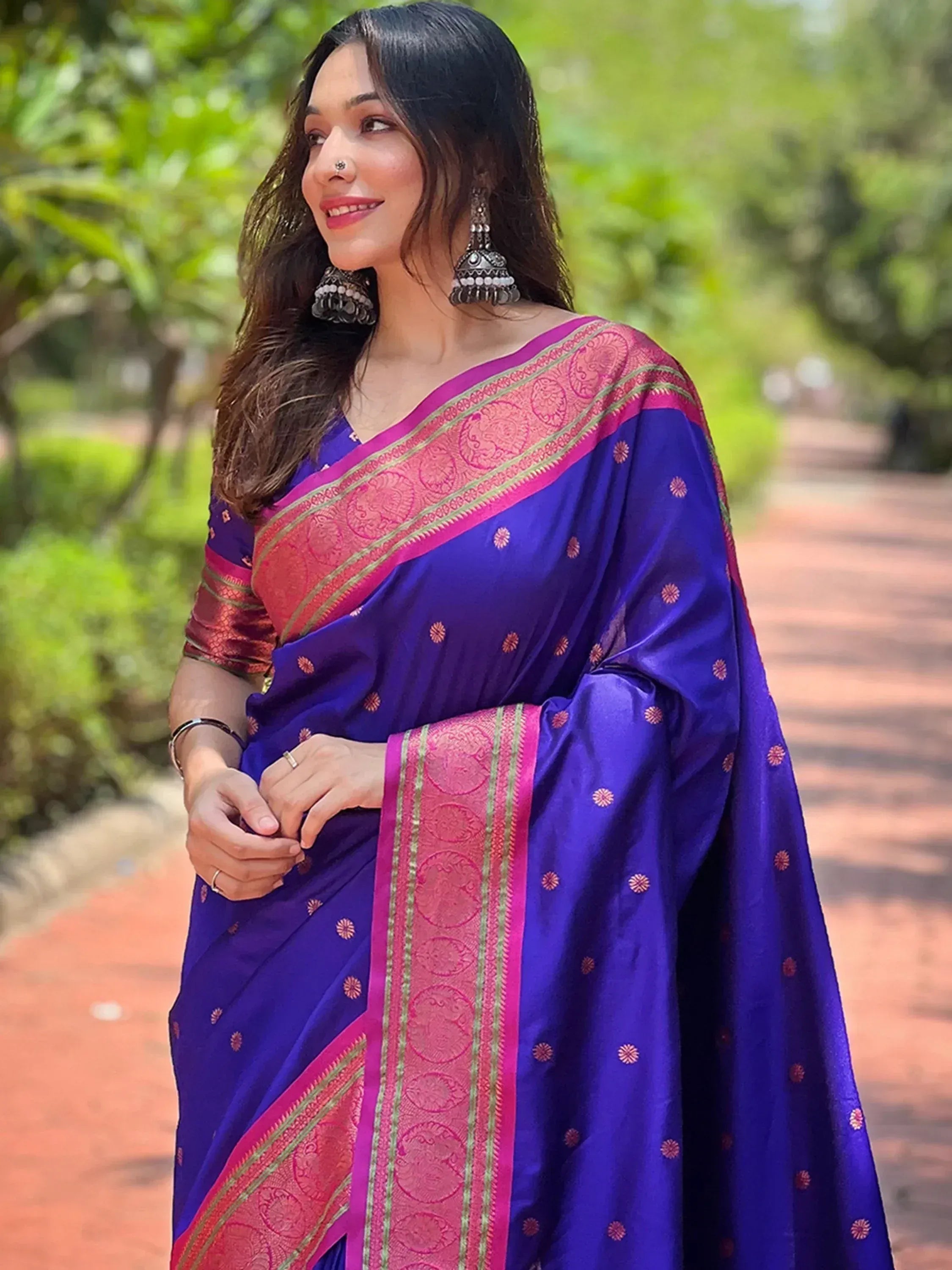 Woman in royal blue saree with pink gold border, ethnic wear for festive occasions