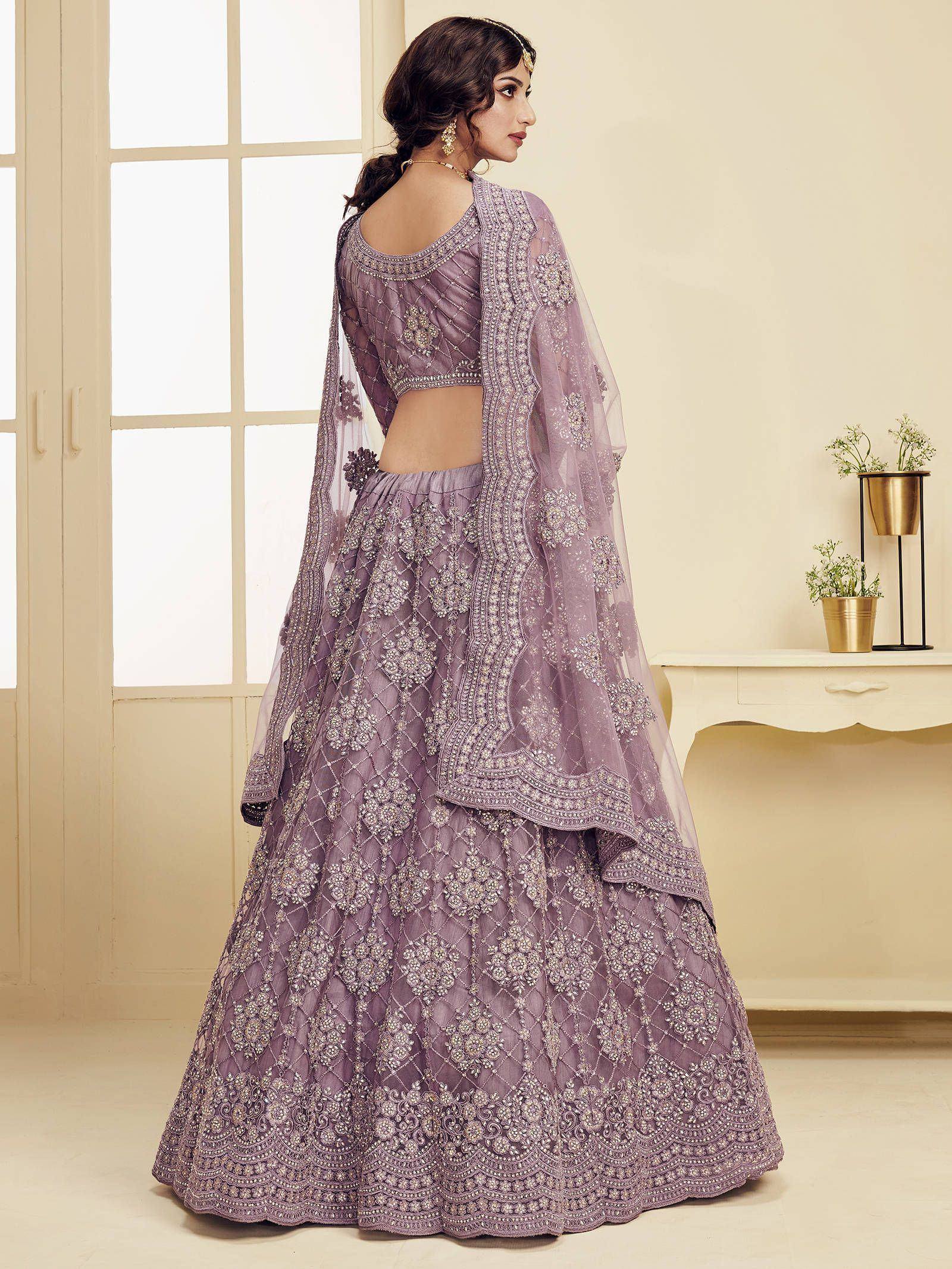 Lavender designer lehenga choli with heavy embroidery and sheer dupatta, perfect for Indian weddings and festive occasions.