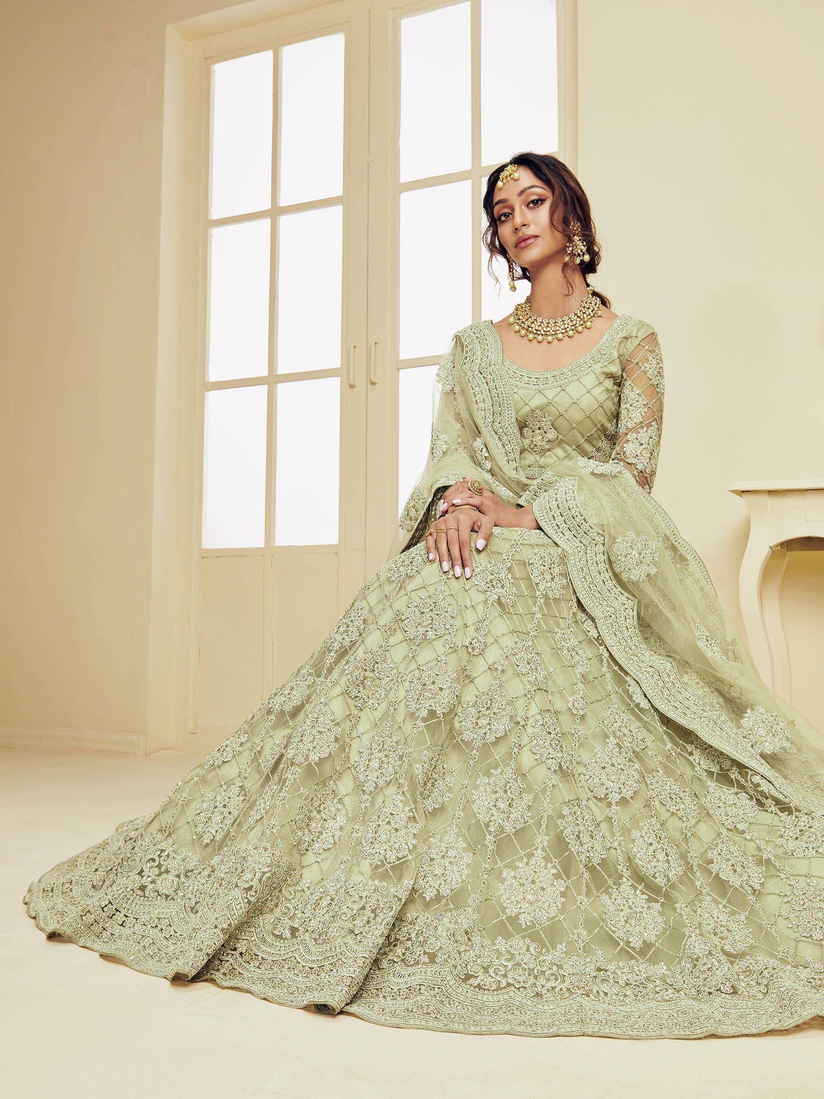 Elegant mint green designer lehenga choli with intricate embroidery and net dupatta, perfect for Indian weddings.