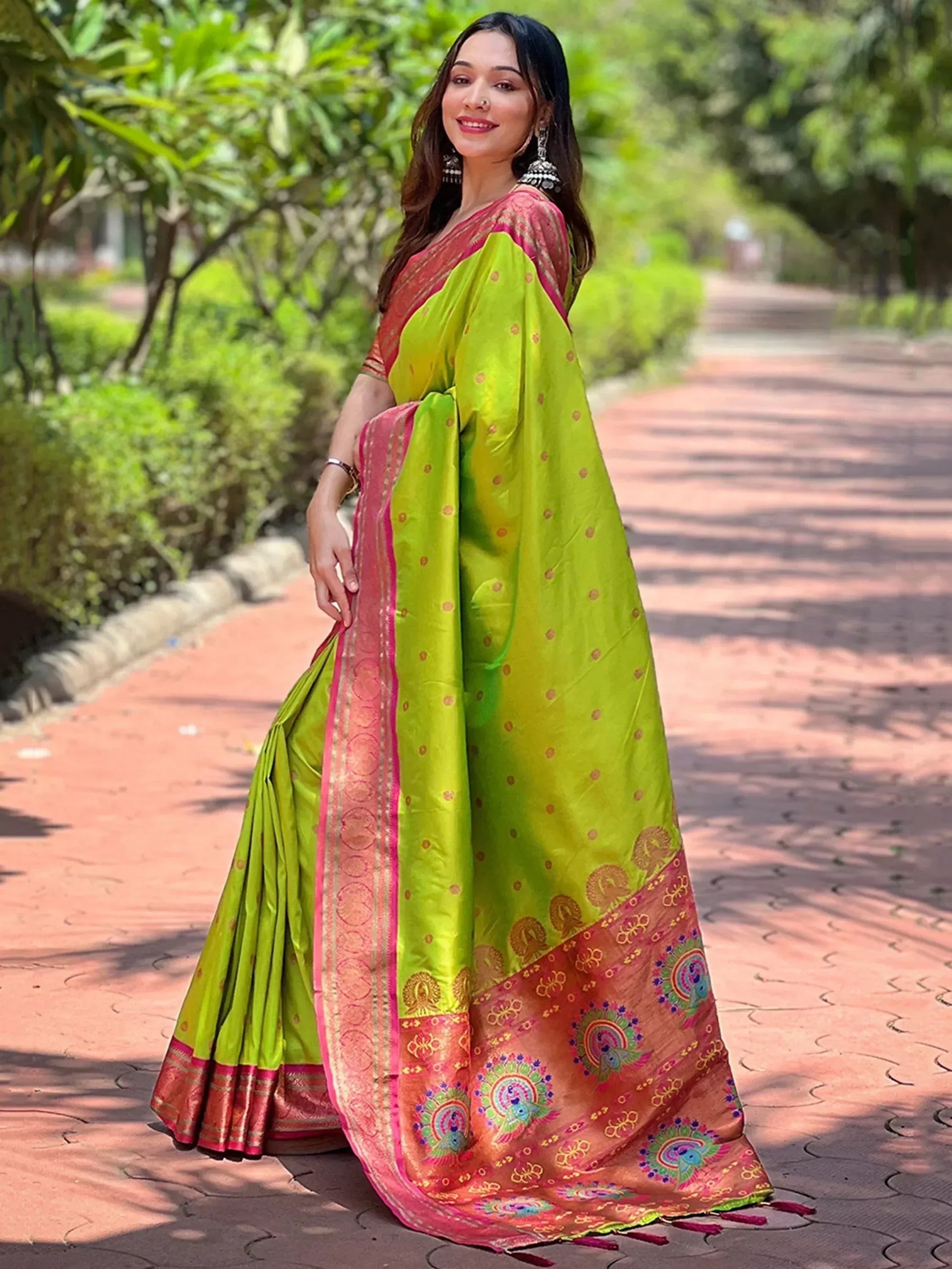 Vibrant green and pink Indian saree with peacock motifs, perfect for ethnic occasions