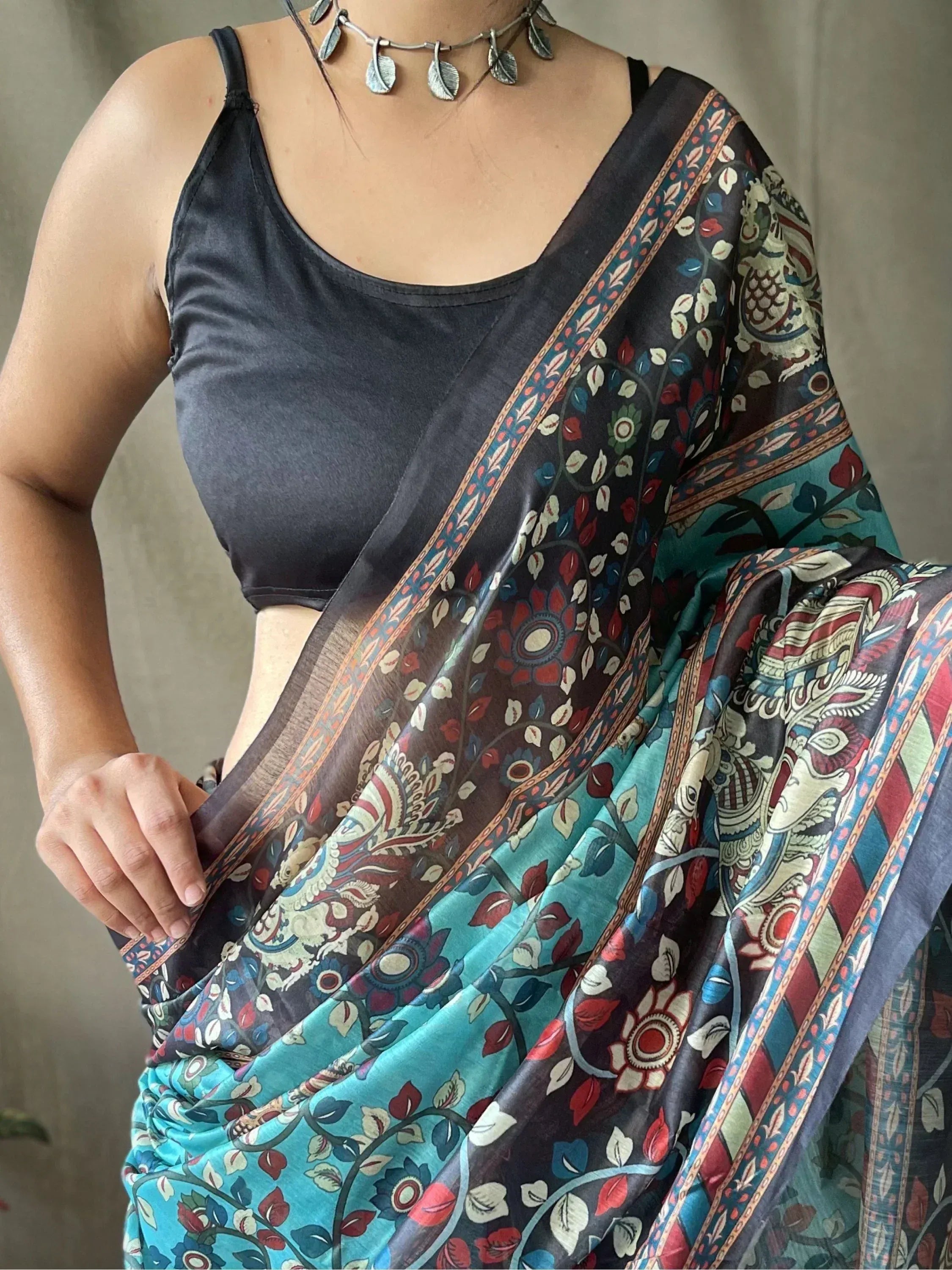 Woman wearing floral printed saree with black blouse, ethnic Indian wear