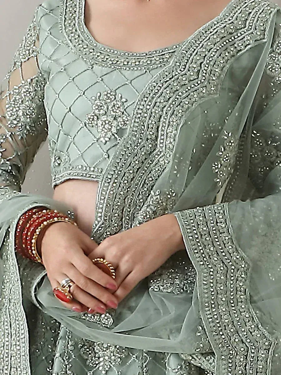 Elegant sage green embroidered salwar kameez with detailed beadwork and sheer sleeves
