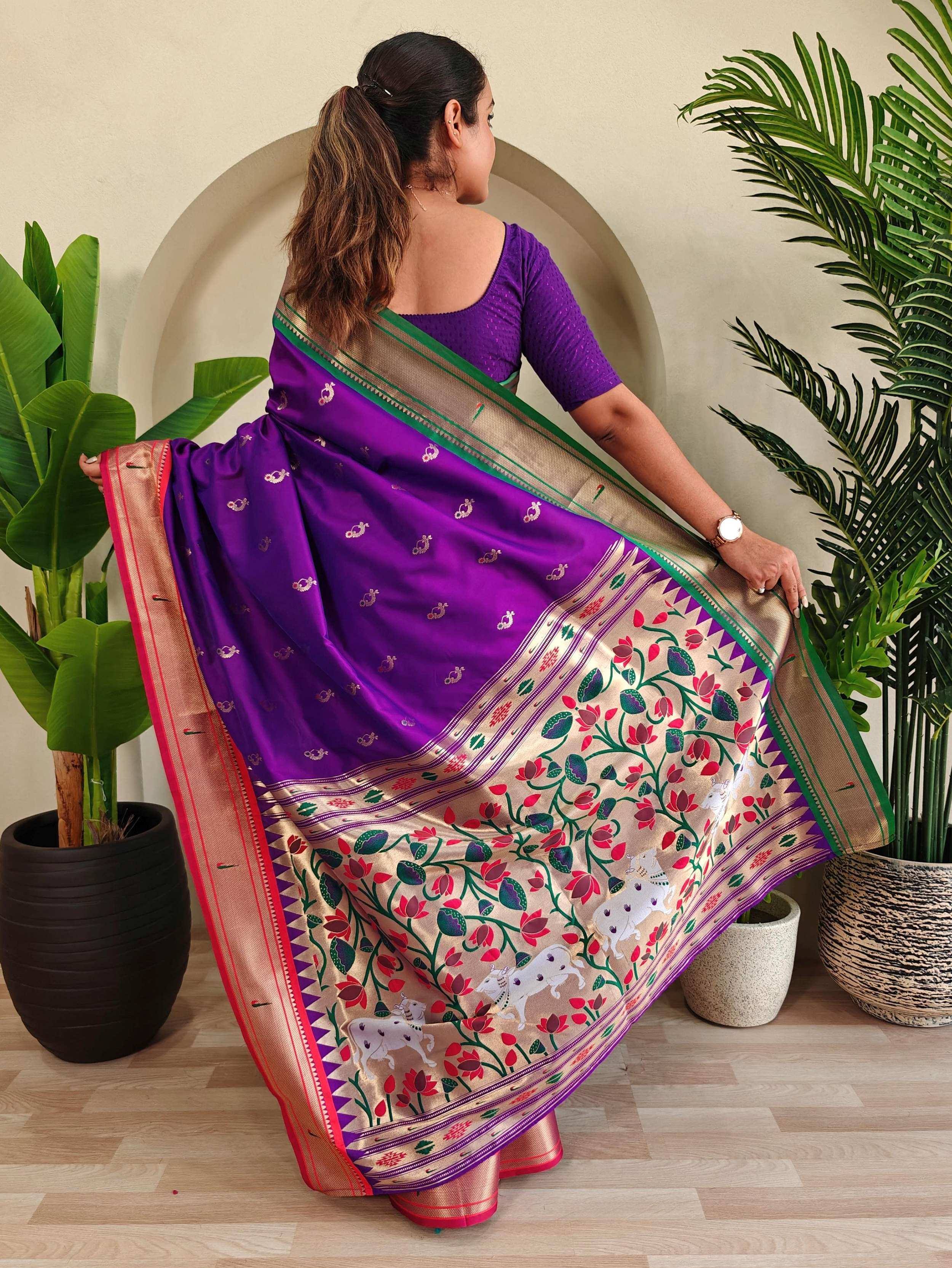 Purple ethnic saree with floral and cow print border, paired with matching blouse, ideal for Indian occasions