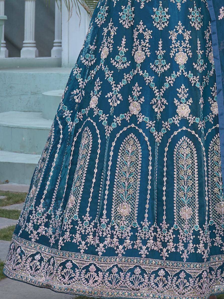 Teal designer lehenga with intricate gold and turquoise embroidery, perfect for Indian ethnic wear occasions.