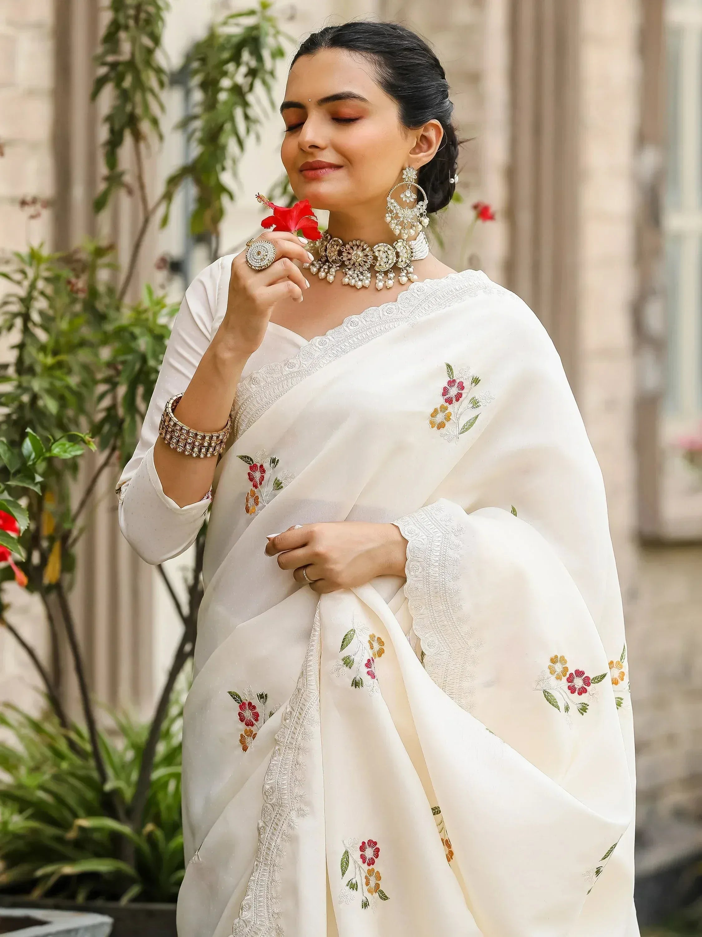 White floral embroidered saree with lace border, styled with traditional jewelry for Indian ethnic wear