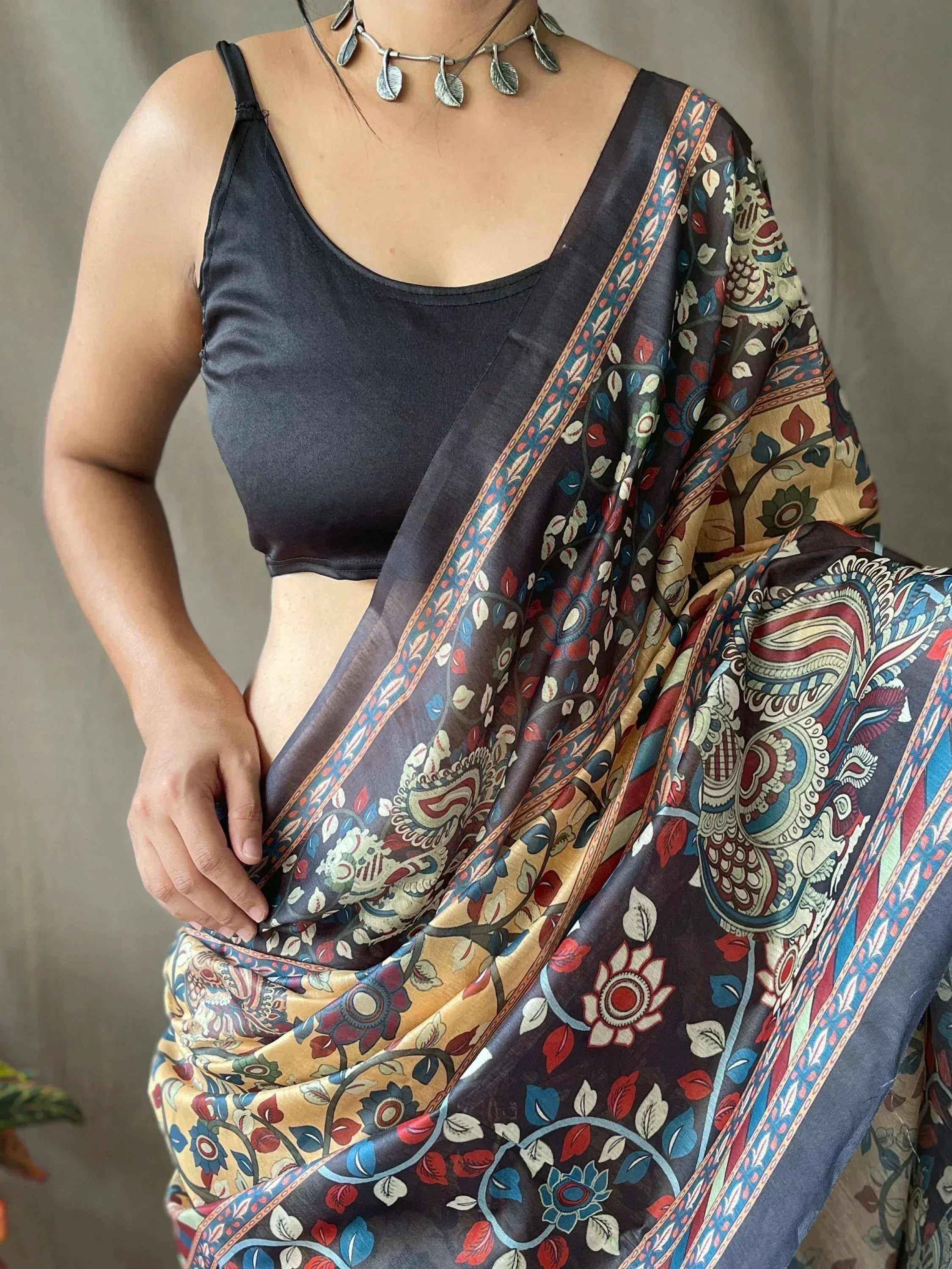 Woman wearing floral printed saree with black blouse, ethnic Indian wear