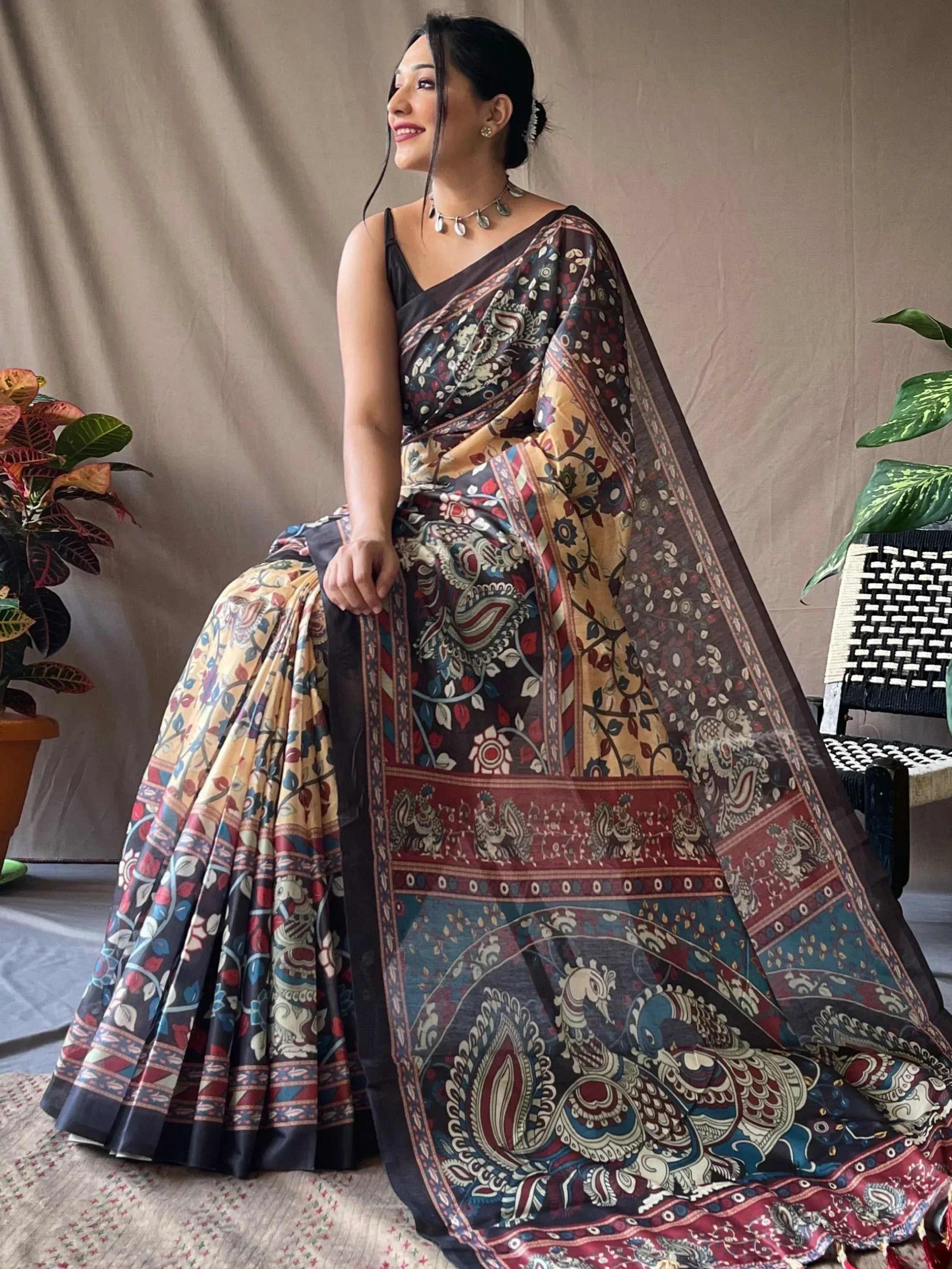 Woman in elegant printed saree with peacock and floral motifs, perfect for ethnic occasions