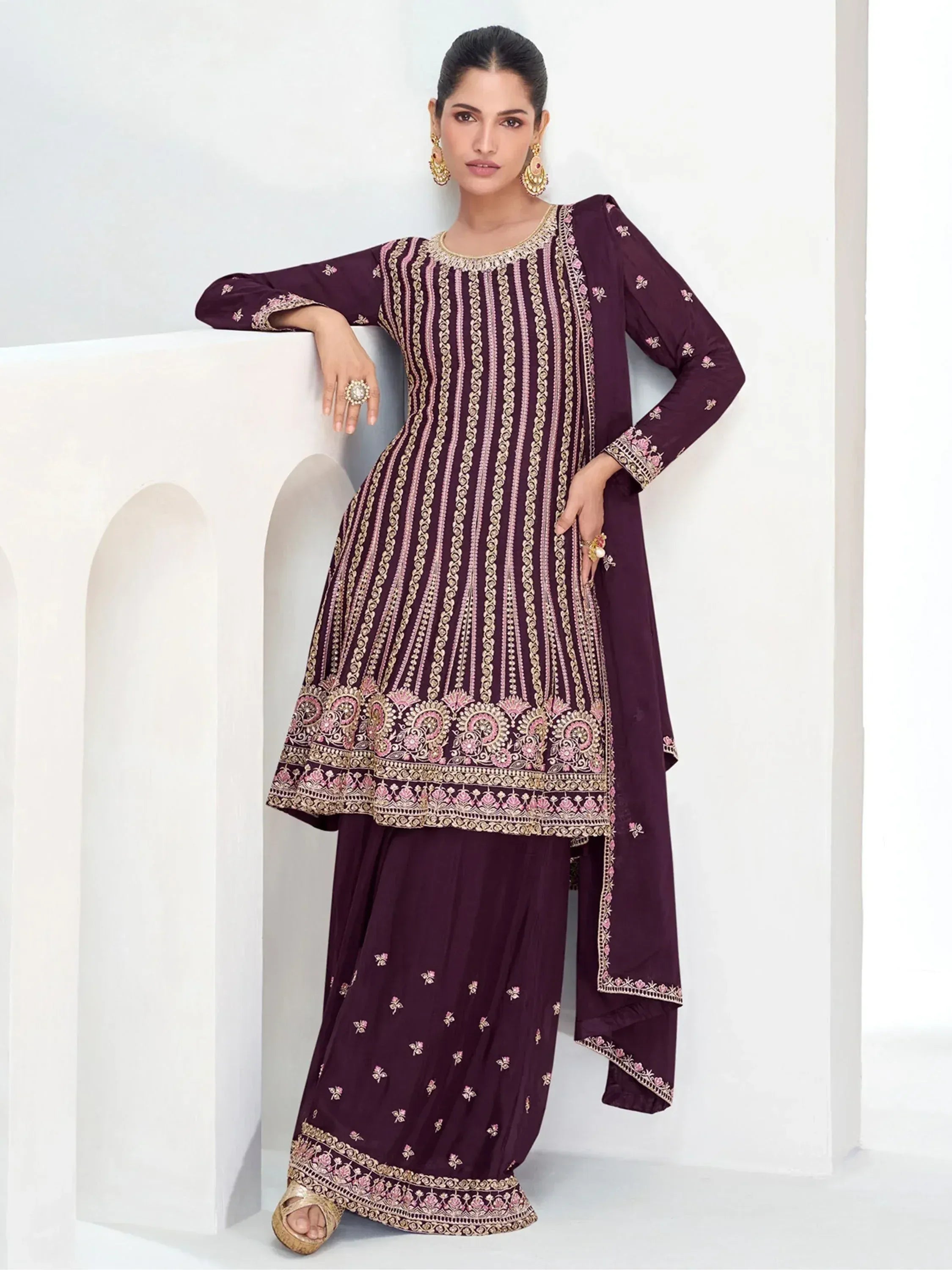 Elegant maroon ethnic salwar kameez with gold and pink embroidery, perfect for festive occasions.