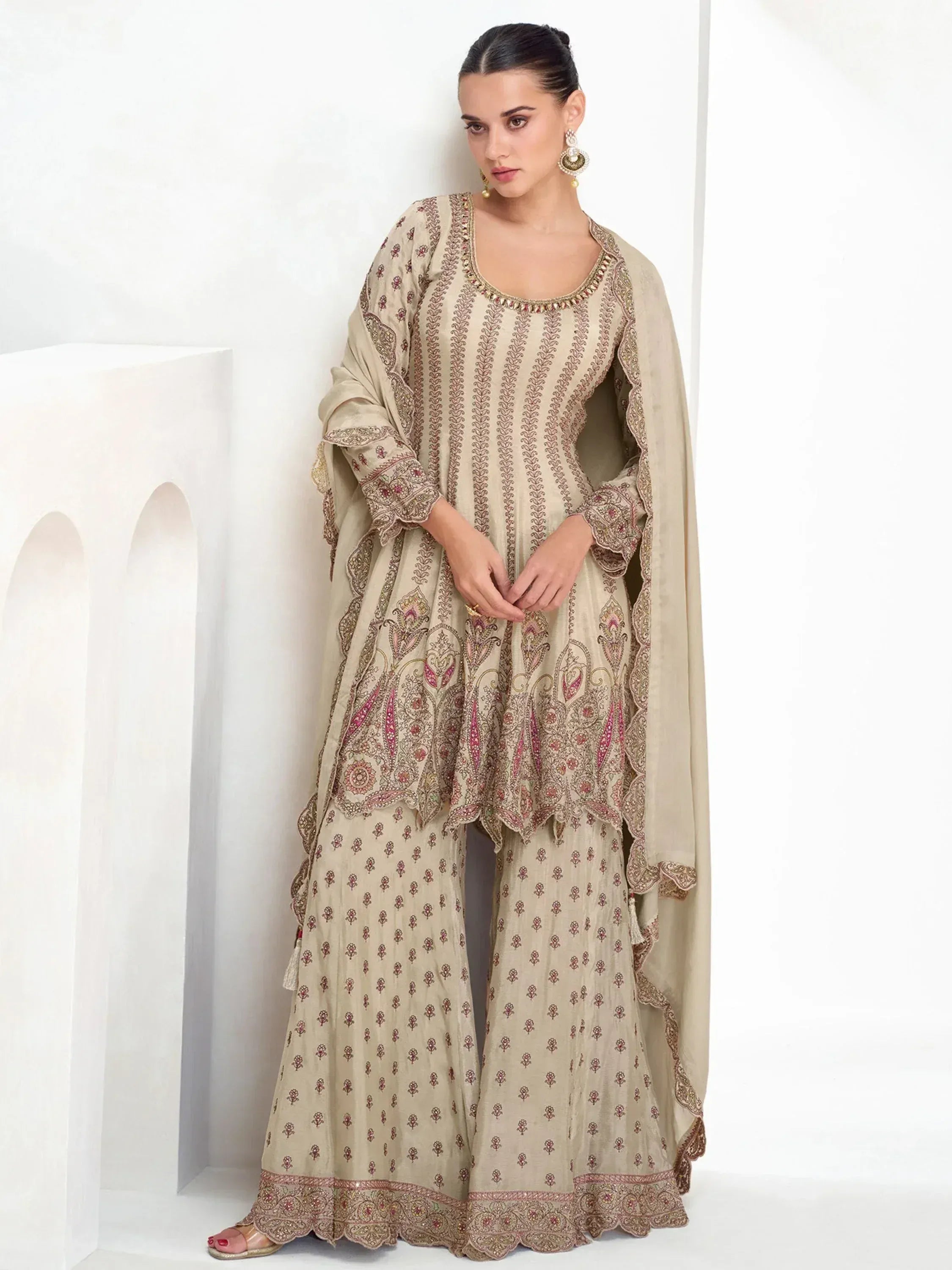 Beige embroidered salwar kameez with intricate paisley design and matching dupatta, ideal for ethnic occasions