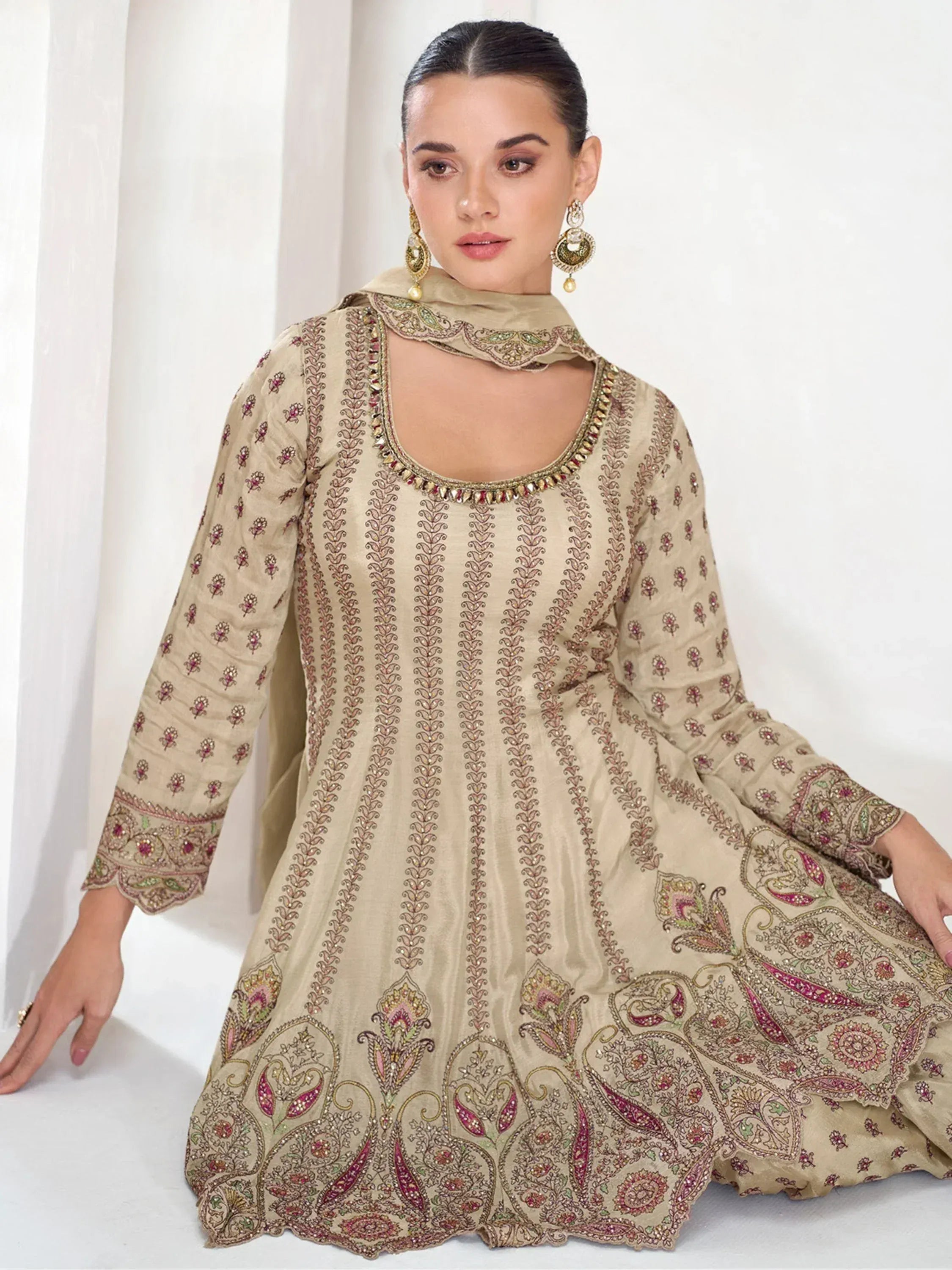 Beige embroidered anarkali suit with floral and paisley motifs, perfect for Indian ethnic wear occasions.