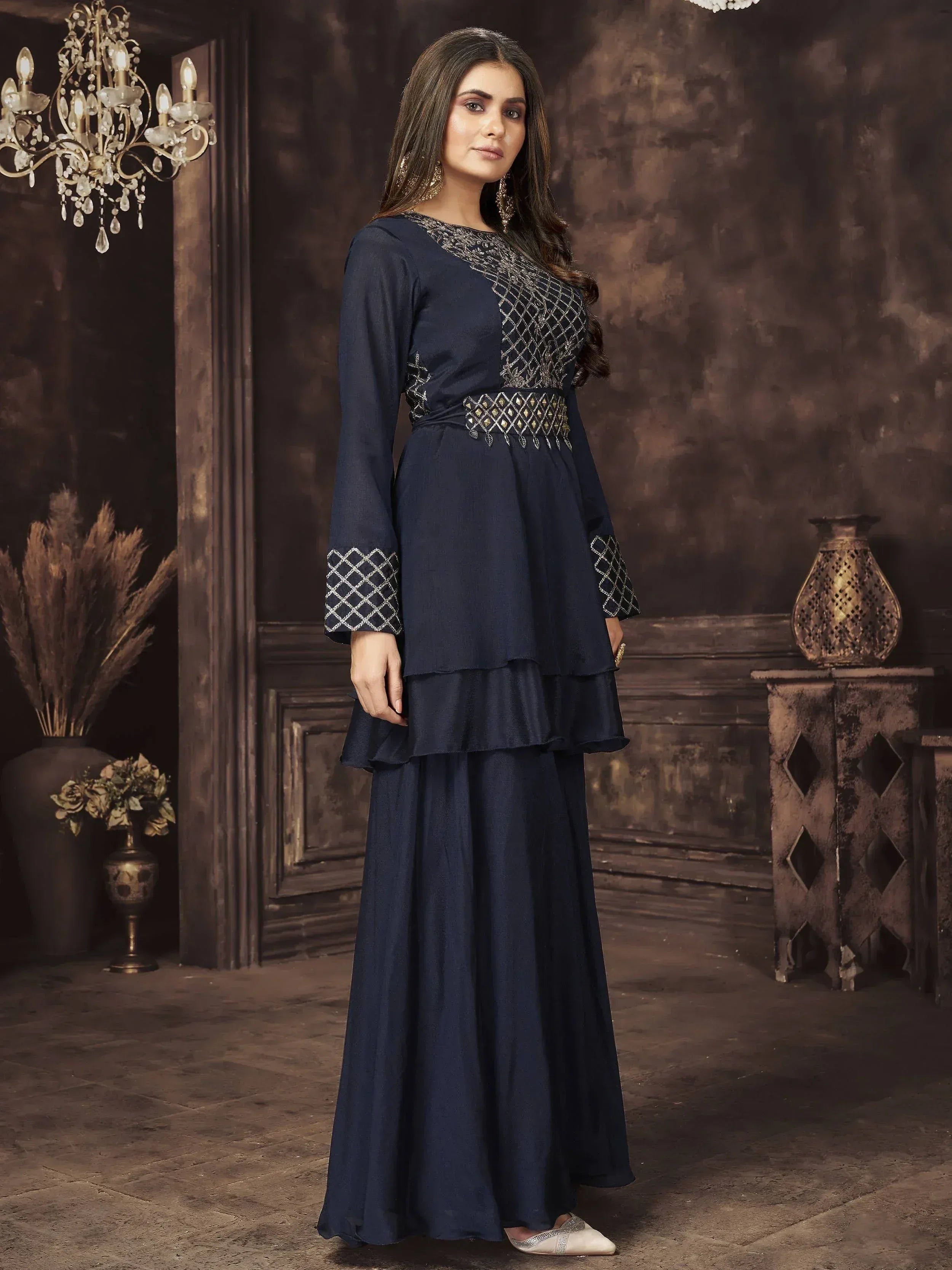Navy blue ethnic gown with silver embroidery, tiered skirt, and bell sleeves for festive occasions