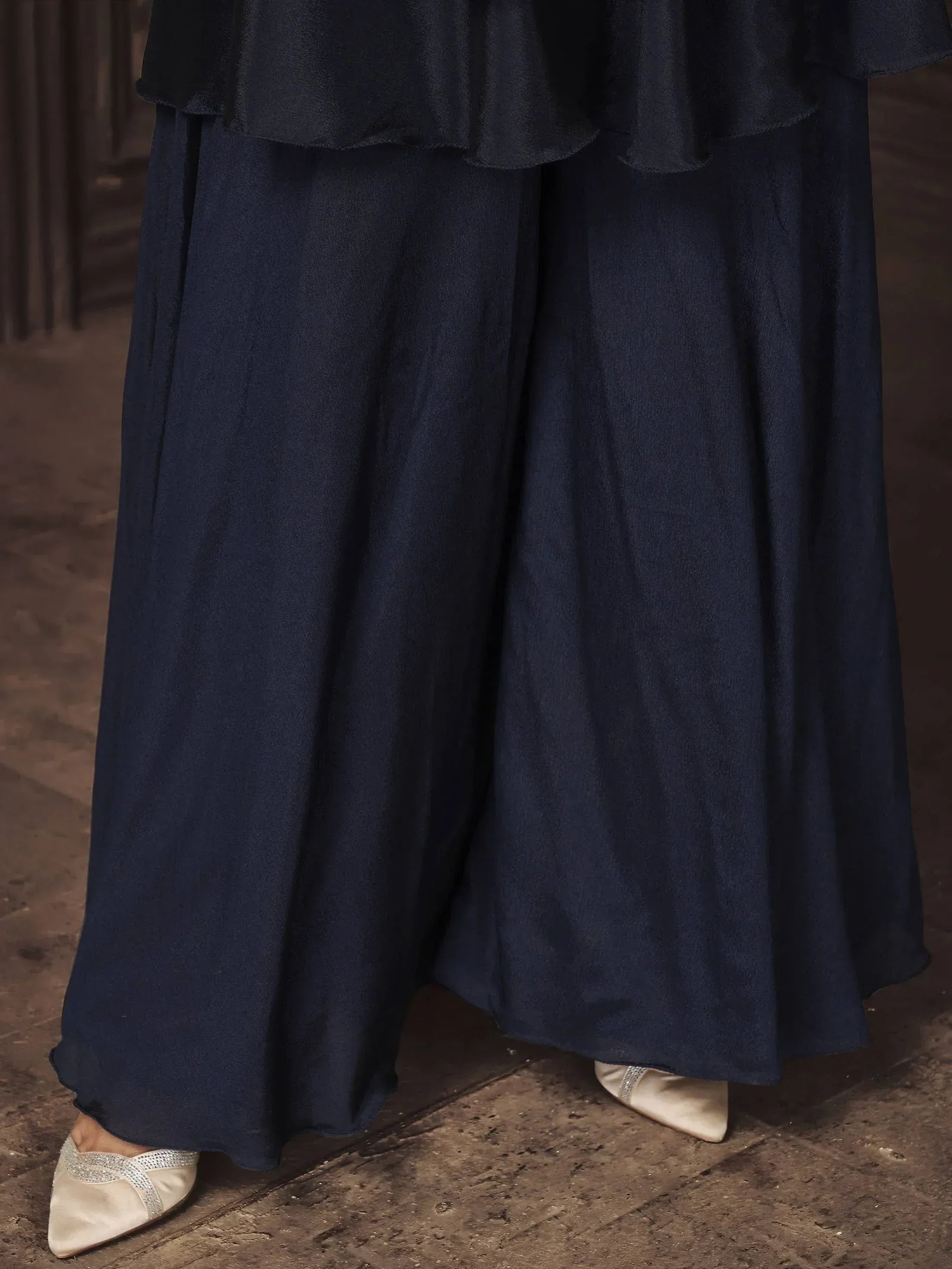 Navy blue ethnic palazzo pants with ruffled top, paired with cream embellished flats for Indian wear