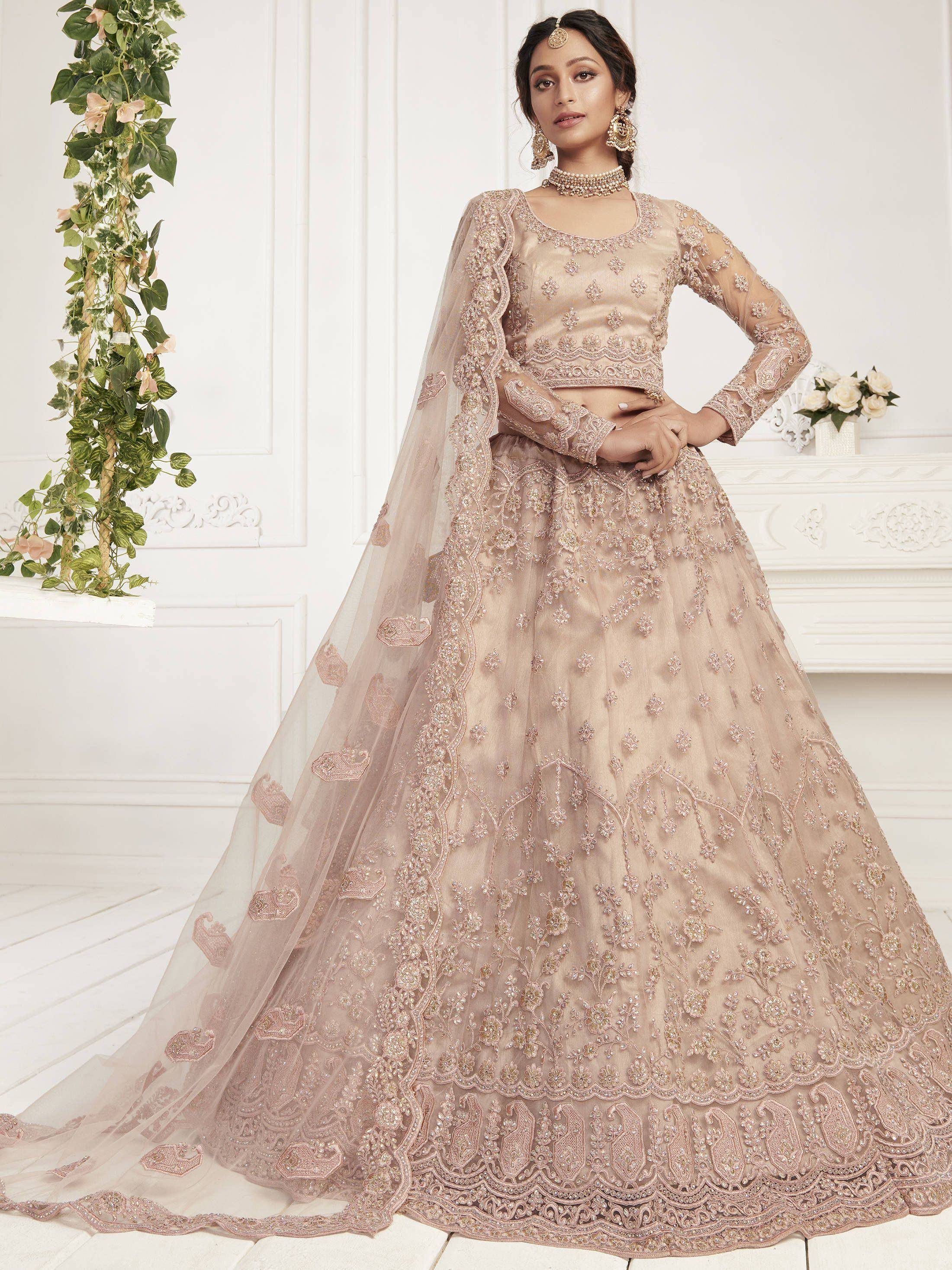 Elegant beige embroidered lehenga choli with sheer dupatta, perfect for Indian weddings and festive occasions.