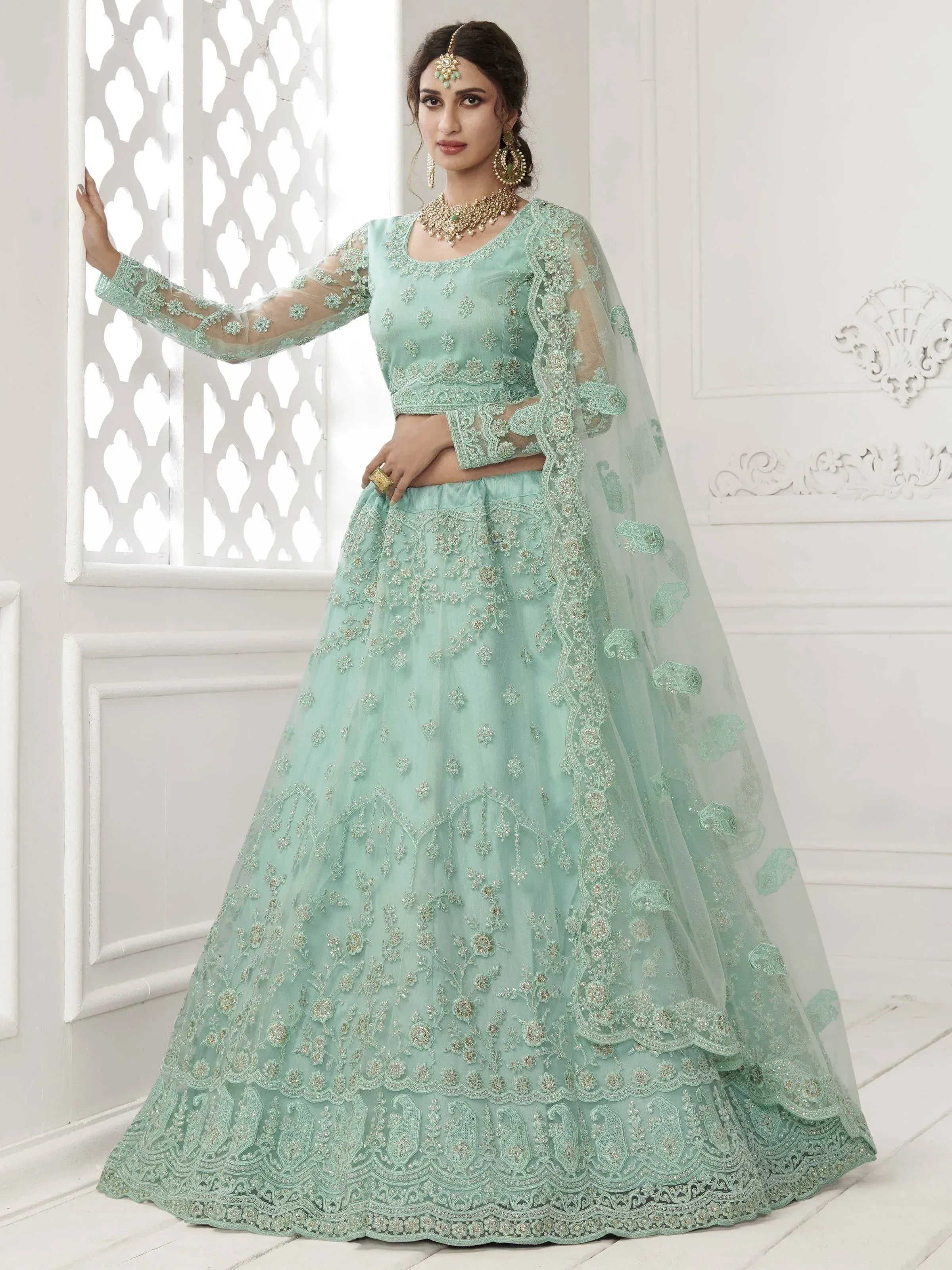 Mint green embroidered lehenga choli with sheer dupatta, perfect for Indian weddings and festive occasions.