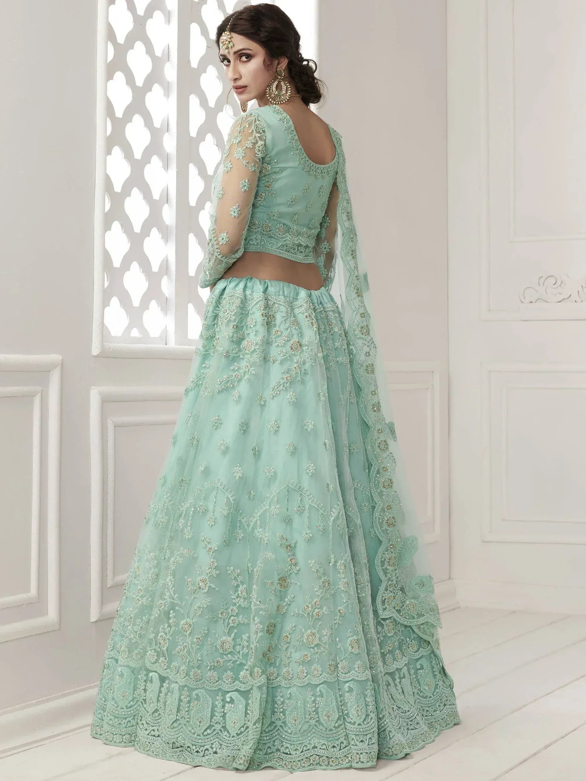 Mint green embroidered lehenga choli with sheer sleeves and dupatta, perfect for Indian weddings and festive occasions