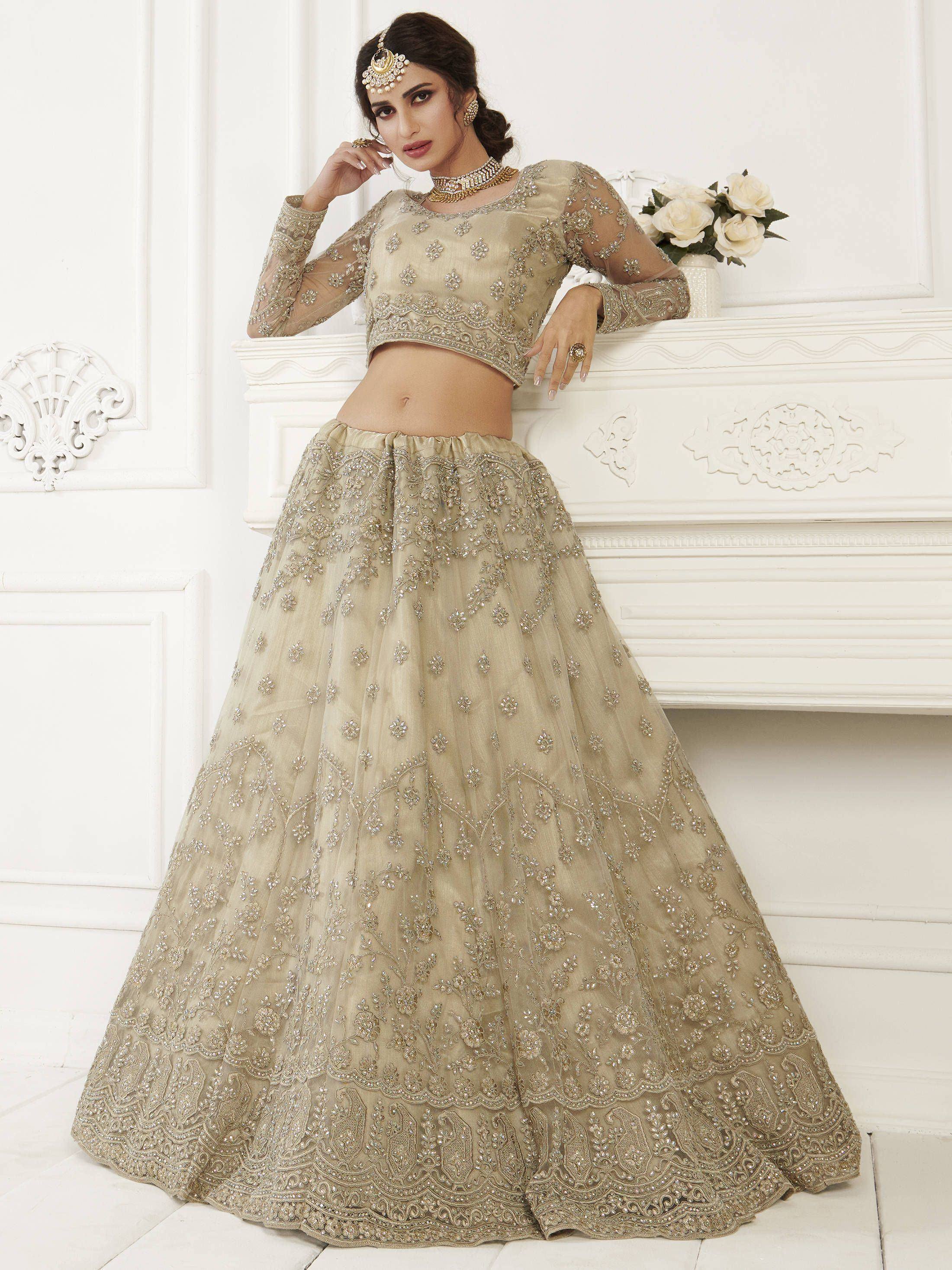Beige embroidered lehenga choli with sheer sleeves, perfect for Indian weddings and festive occasions