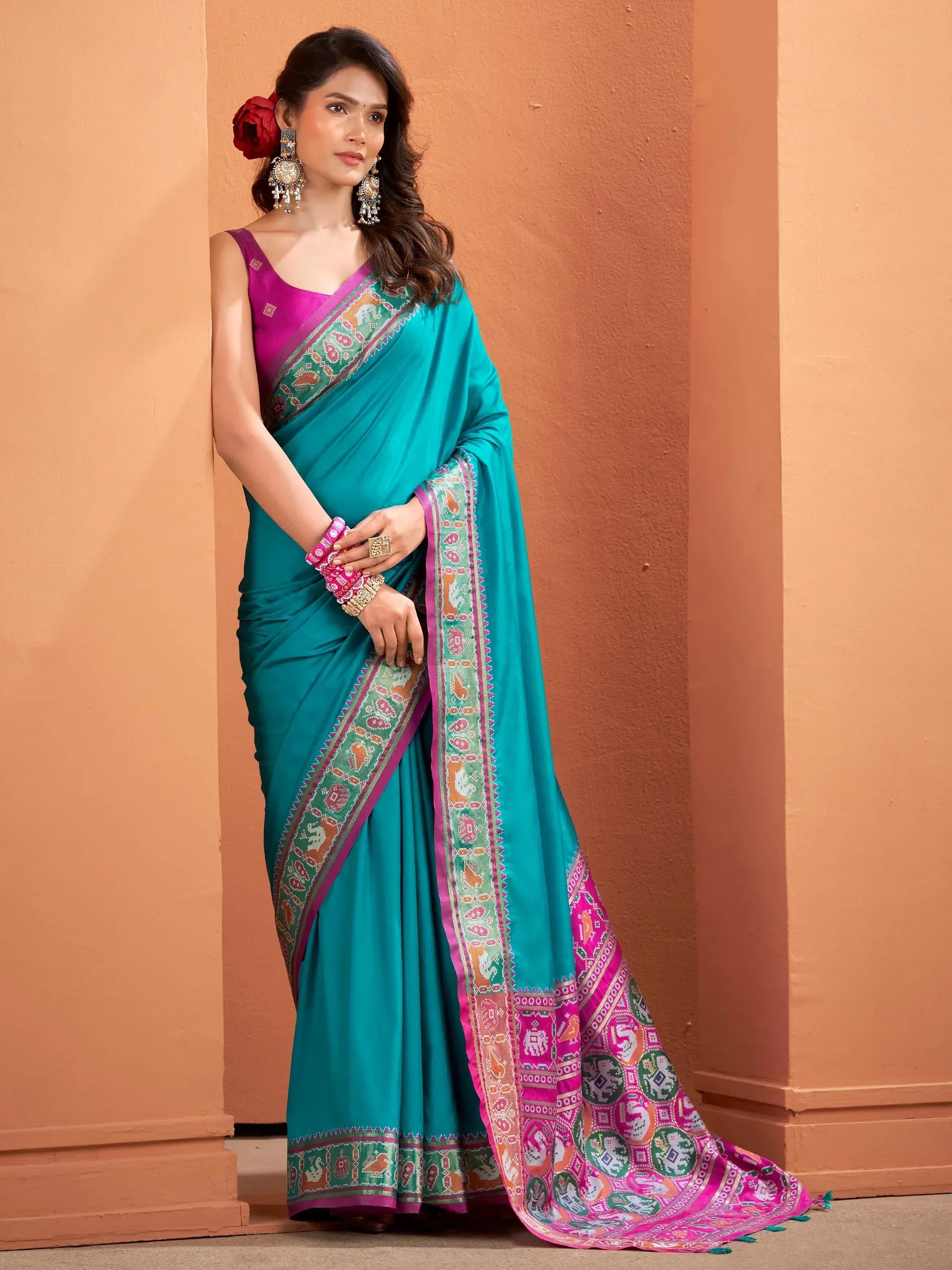 Teal saree with pink border and elephant print, paired with purple blouse, Indian ethnic wear