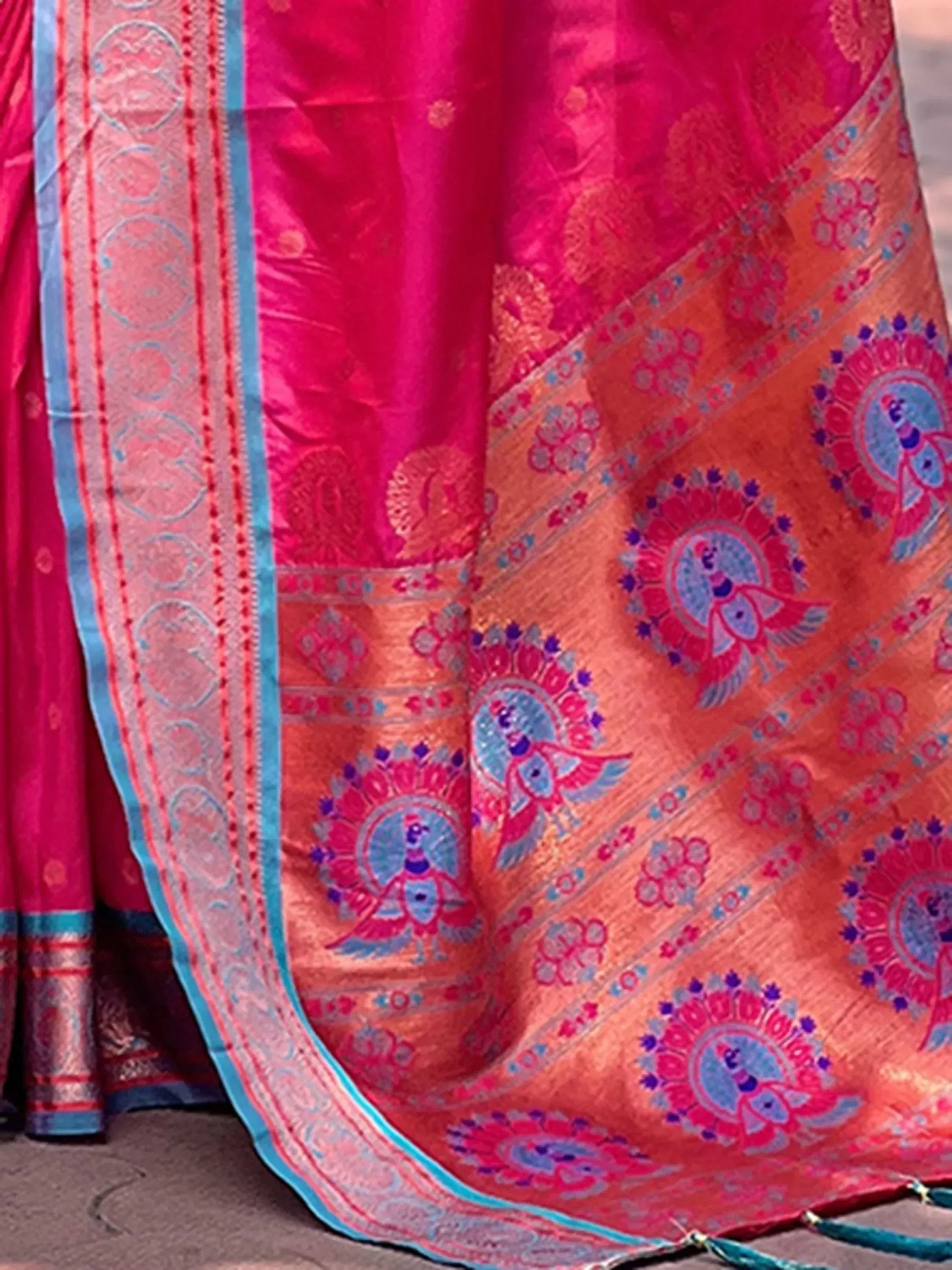 Vibrant pink and orange designer lehenga with peacock motifs and intricate border detailing