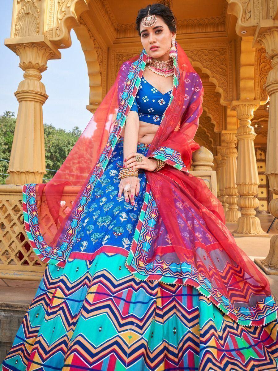 Vibrant blue and red printed lehenga choli with colorful dupatta, perfect for Indian ethnic occasions