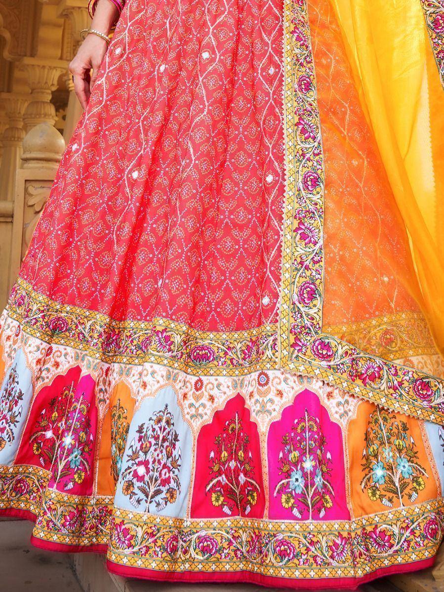 Vibrant red and yellow designer lehenga with intricate floral embroidery and mirror work, perfect for Indian ethnic wear.