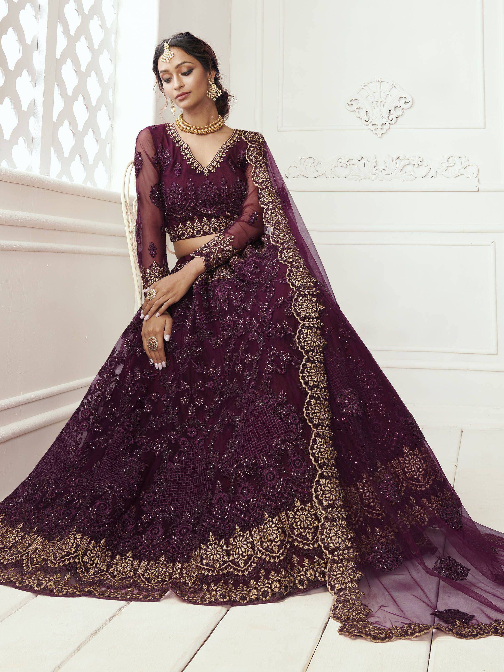 Elegant purple lehenga choli with gold embroidery, perfect for Indian weddings and festive occasions.