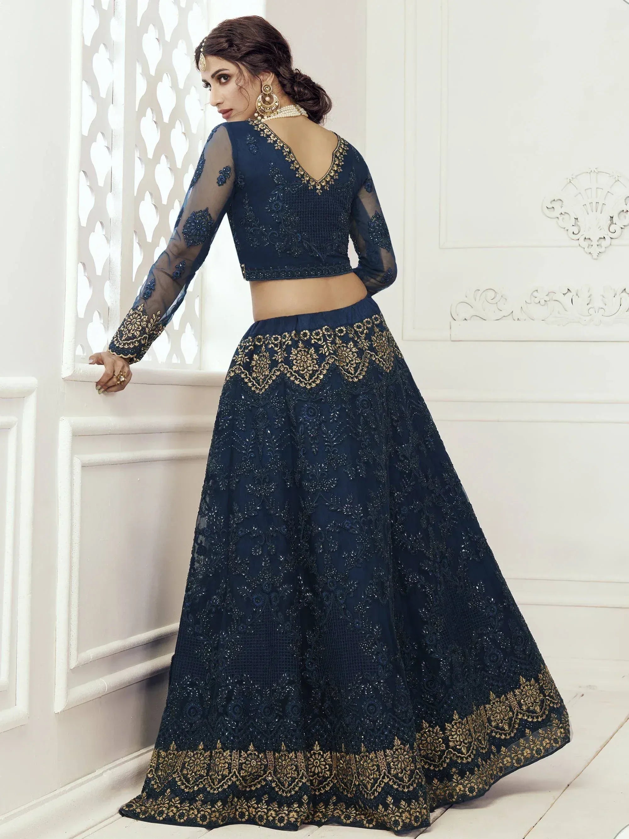 Navy blue designer lehenga choli with gold embroidery, sheer sleeves, and V-back detail for Indian ethnic wear