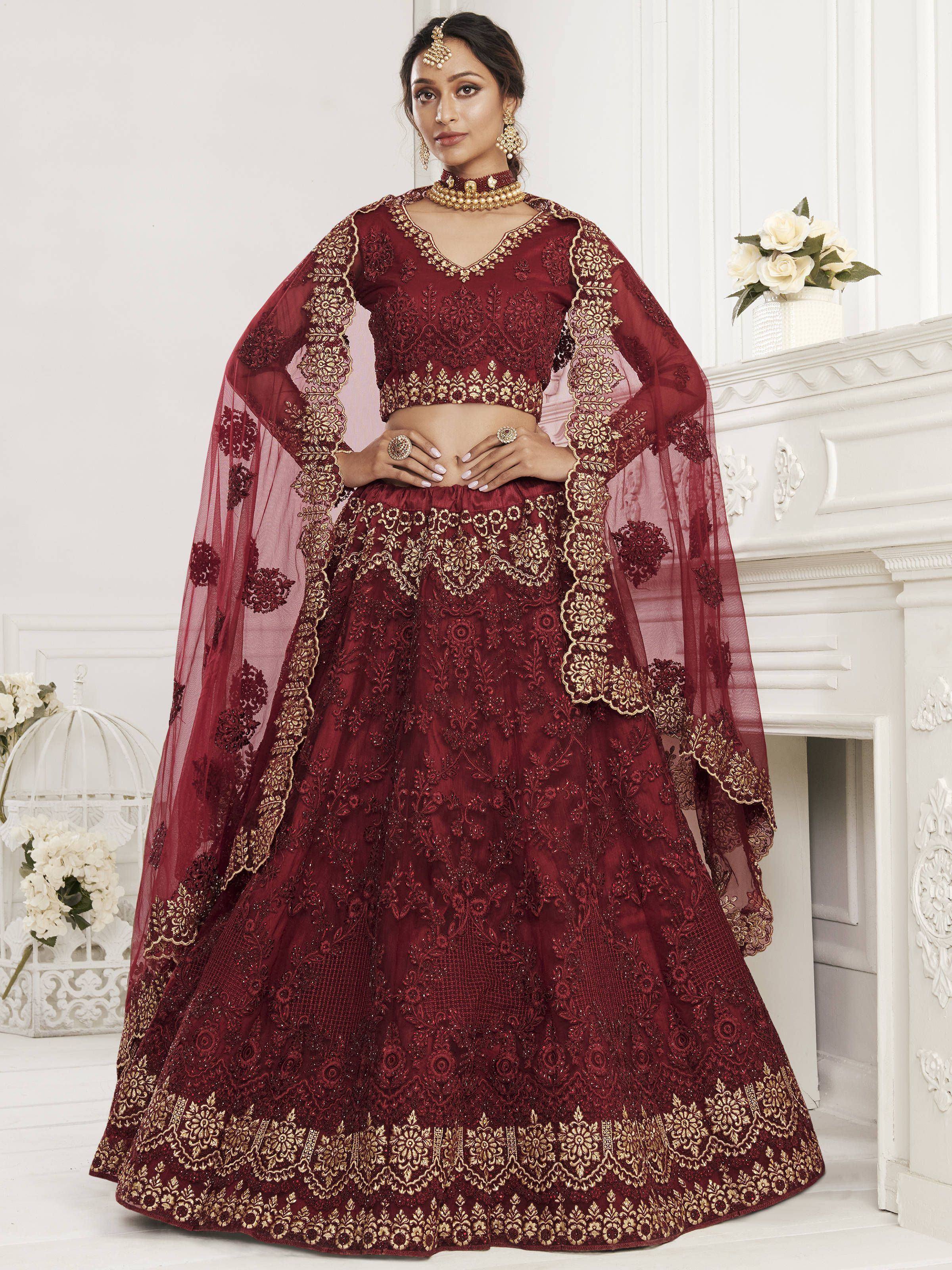 Burgundy designer lehenga choli with gold embroidery and sheer cape for Indian weddings