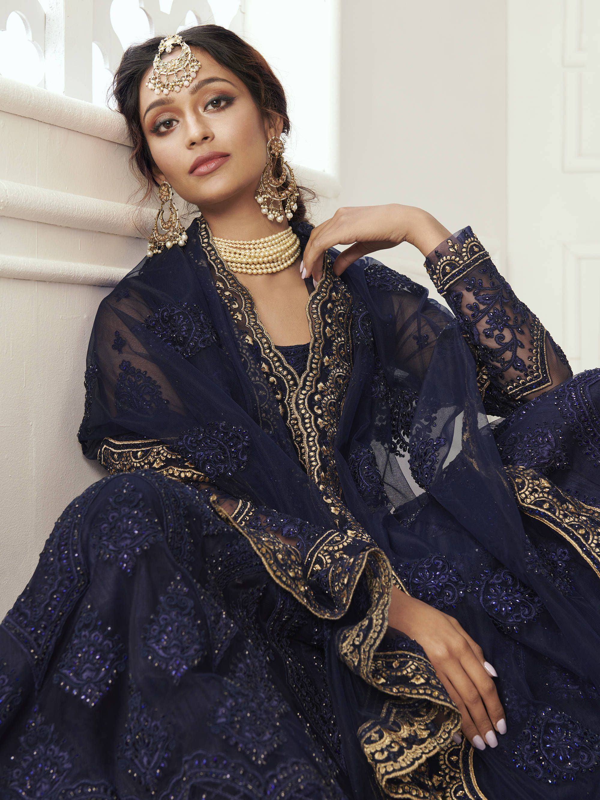 Navy blue embroidered Indian ethnic gown with gold detailing, perfect for weddings and festive occasions.