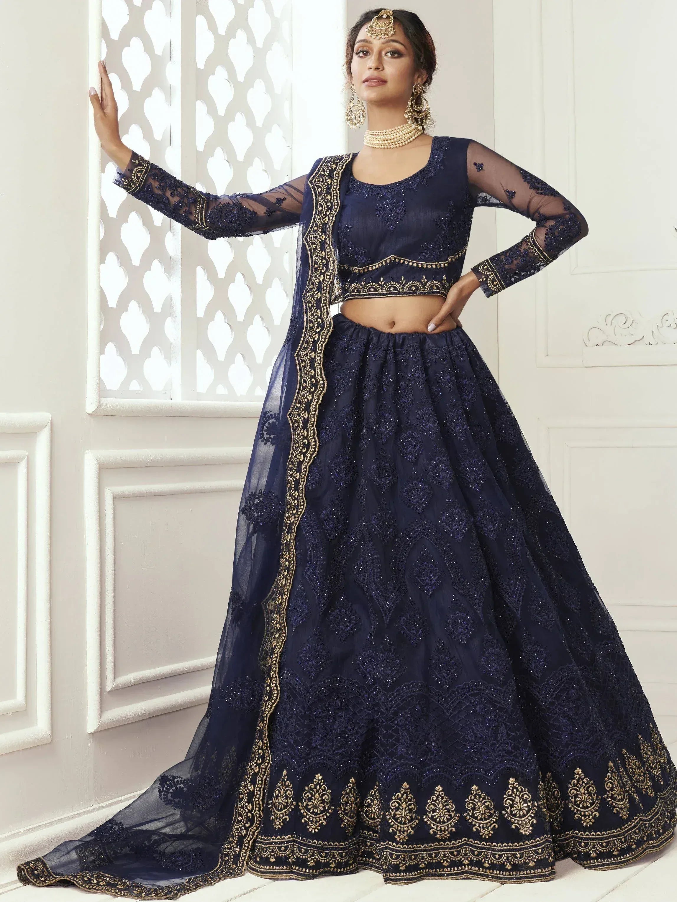 Navy blue embroidered lehenga choli with gold detailing, sheer sleeves, and matching dupatta for Indian ethnic wear