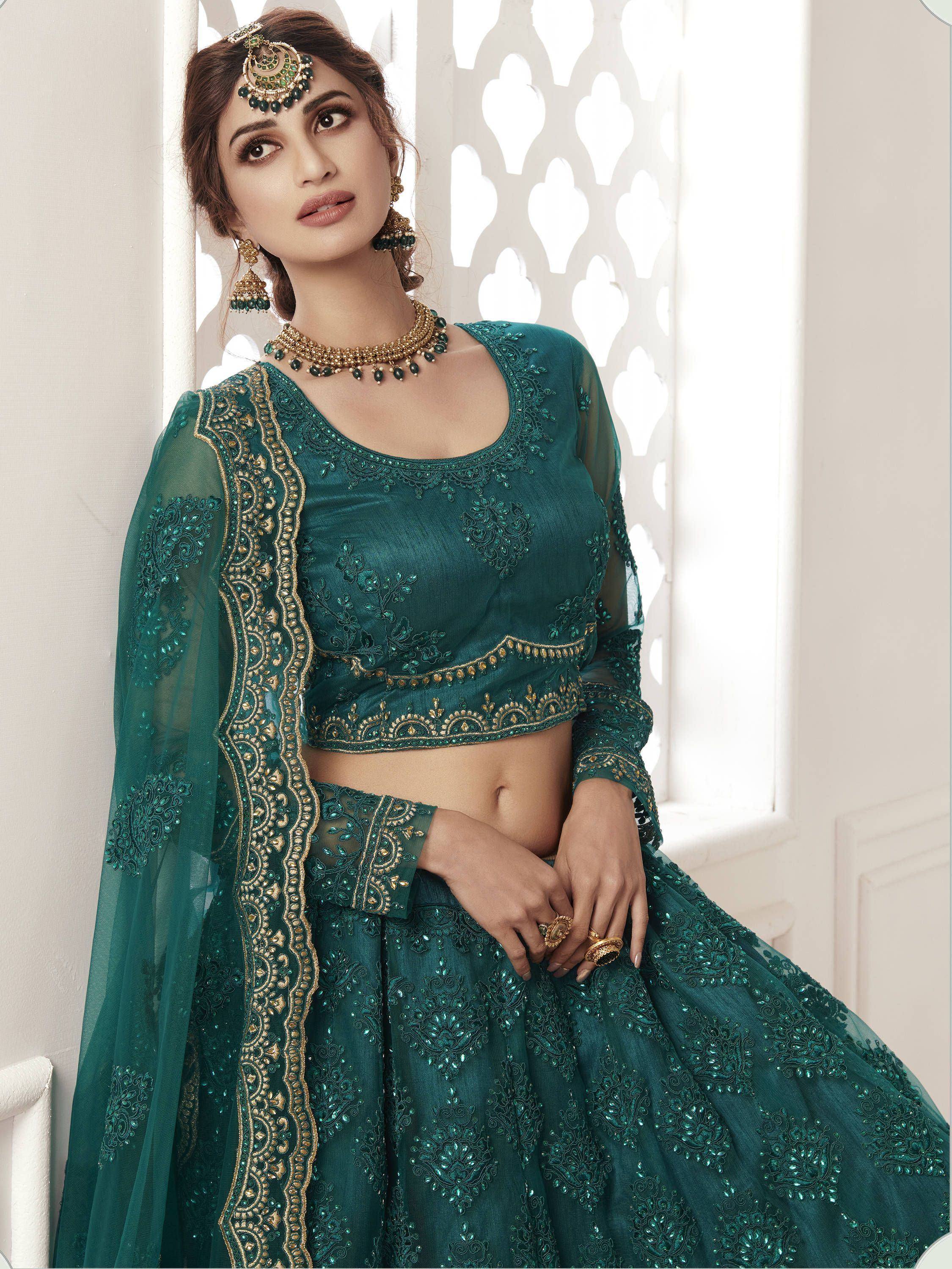 Emerald green designer lehenga choli with gold embroidery and matching jewelry for Indian ethnic wear