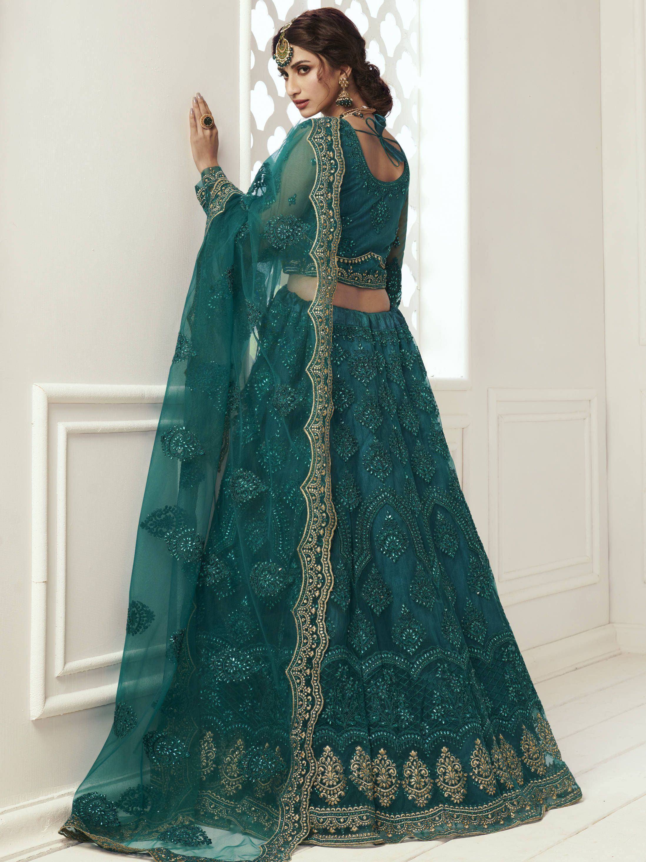 Emerald green designer lehenga choli with gold embroidery and sheer dupatta, perfect for Indian weddings and festive occasions.
