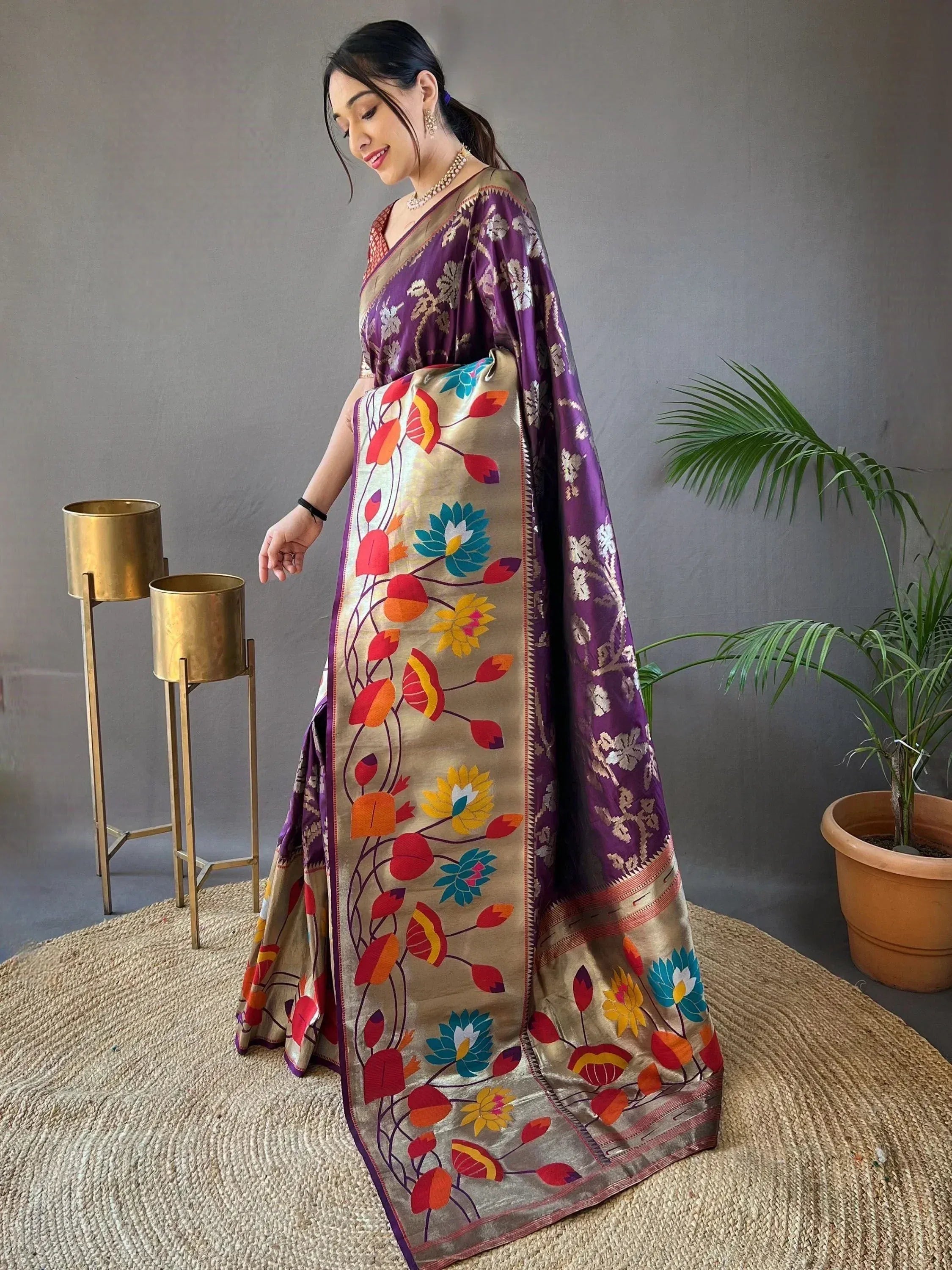 Woman in purple and gold floral saree with vibrant embroidered border, Indian ethnic wear