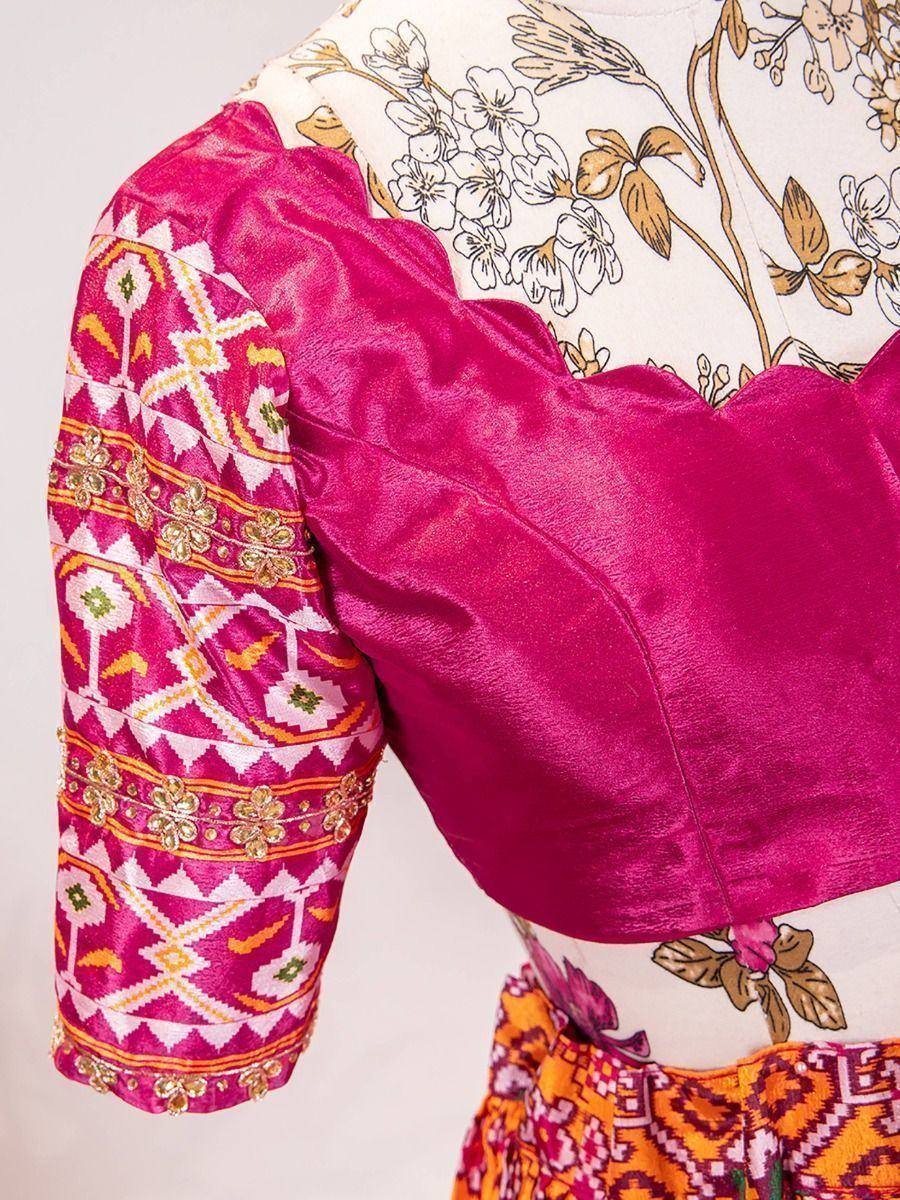 Vibrant pink ethnic blouse with geometric embroidery and floral print, perfect for Indian festive wear