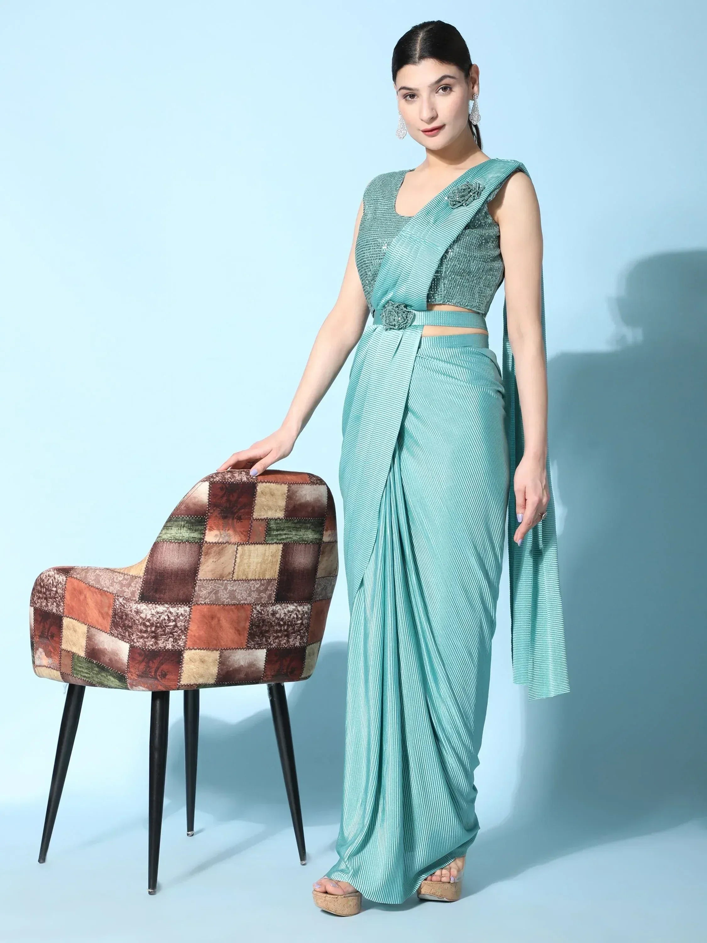 Woman in mint green pleated saree with sequin blouse, ethnic wear for festive occasions
