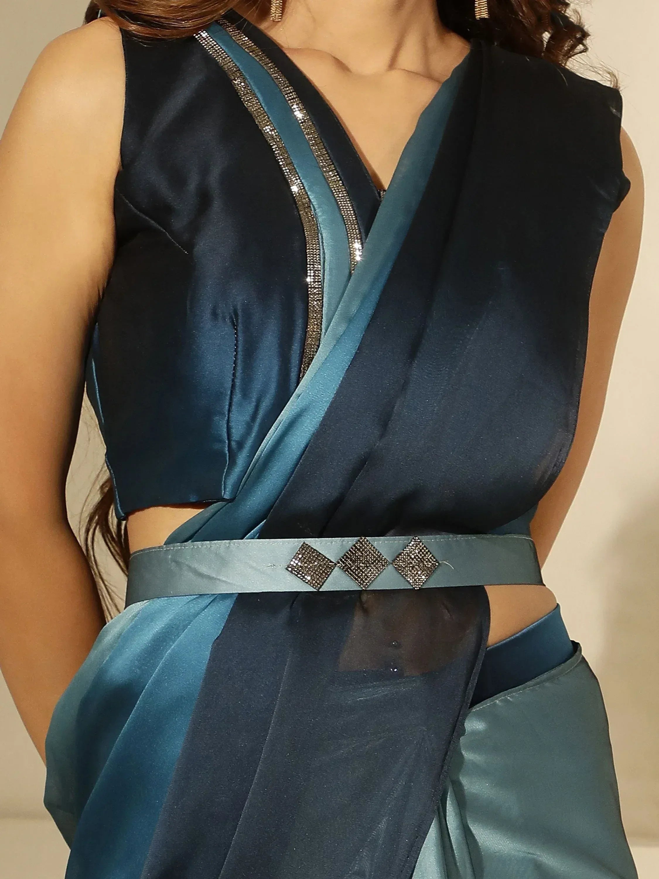 Teal and navy blue satin ethnic gown with crystal embellishments and waist belt, perfect for Indian occasions.