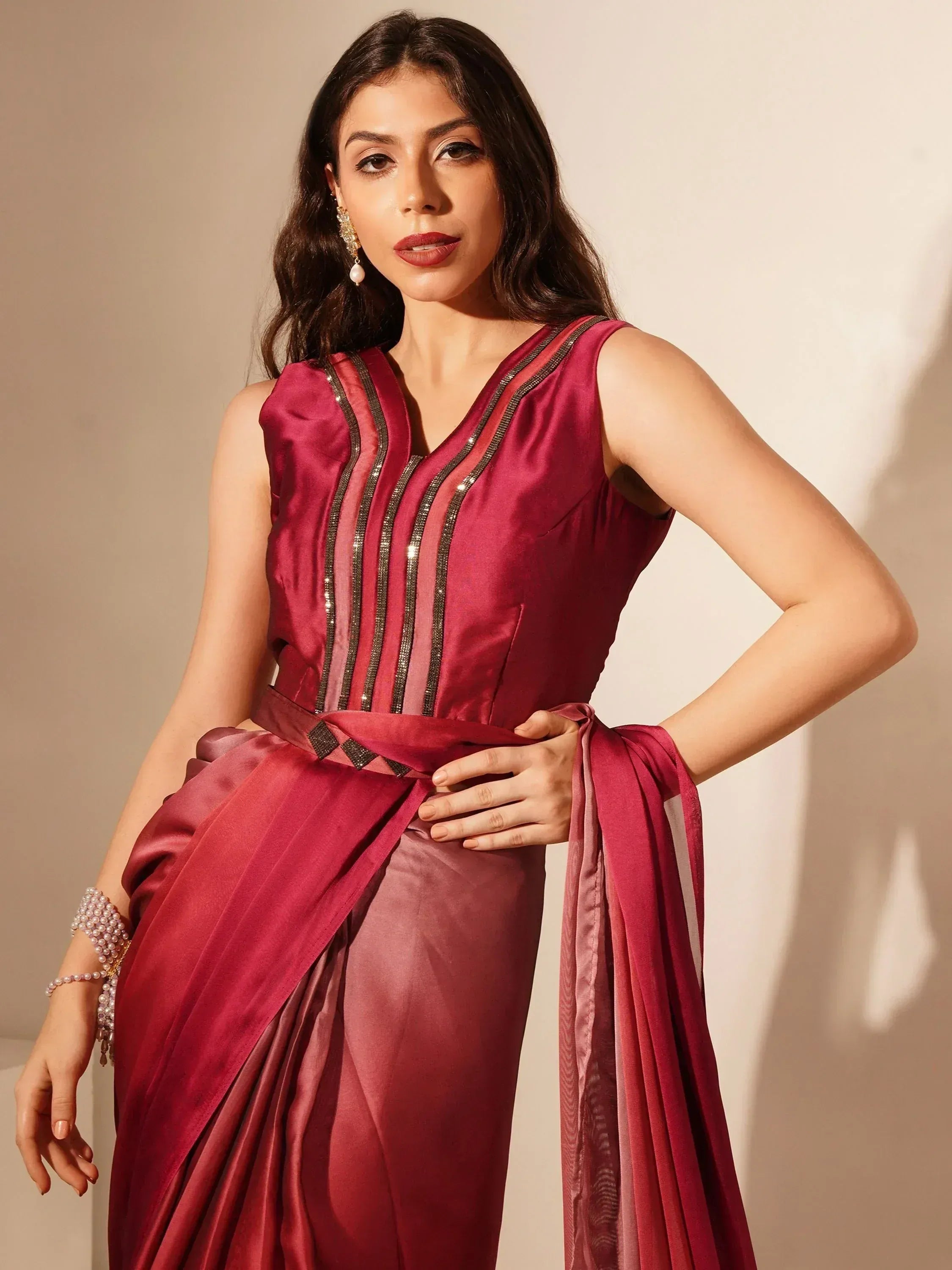 Elegant maroon ethnic gown with sequin detailing and draped sash, perfect for Indian occasions