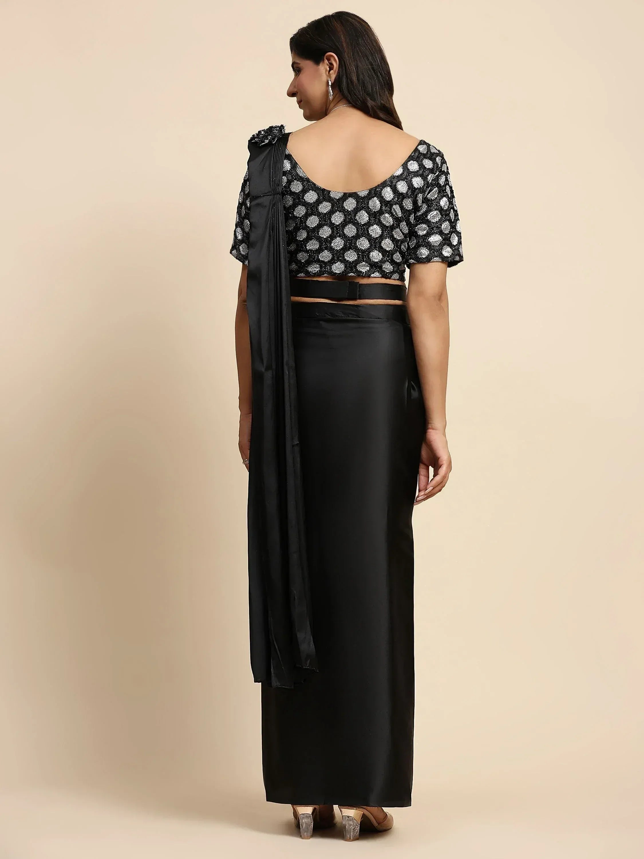 Black ethnic gown with polka dot blouse and pleated drape, back view
