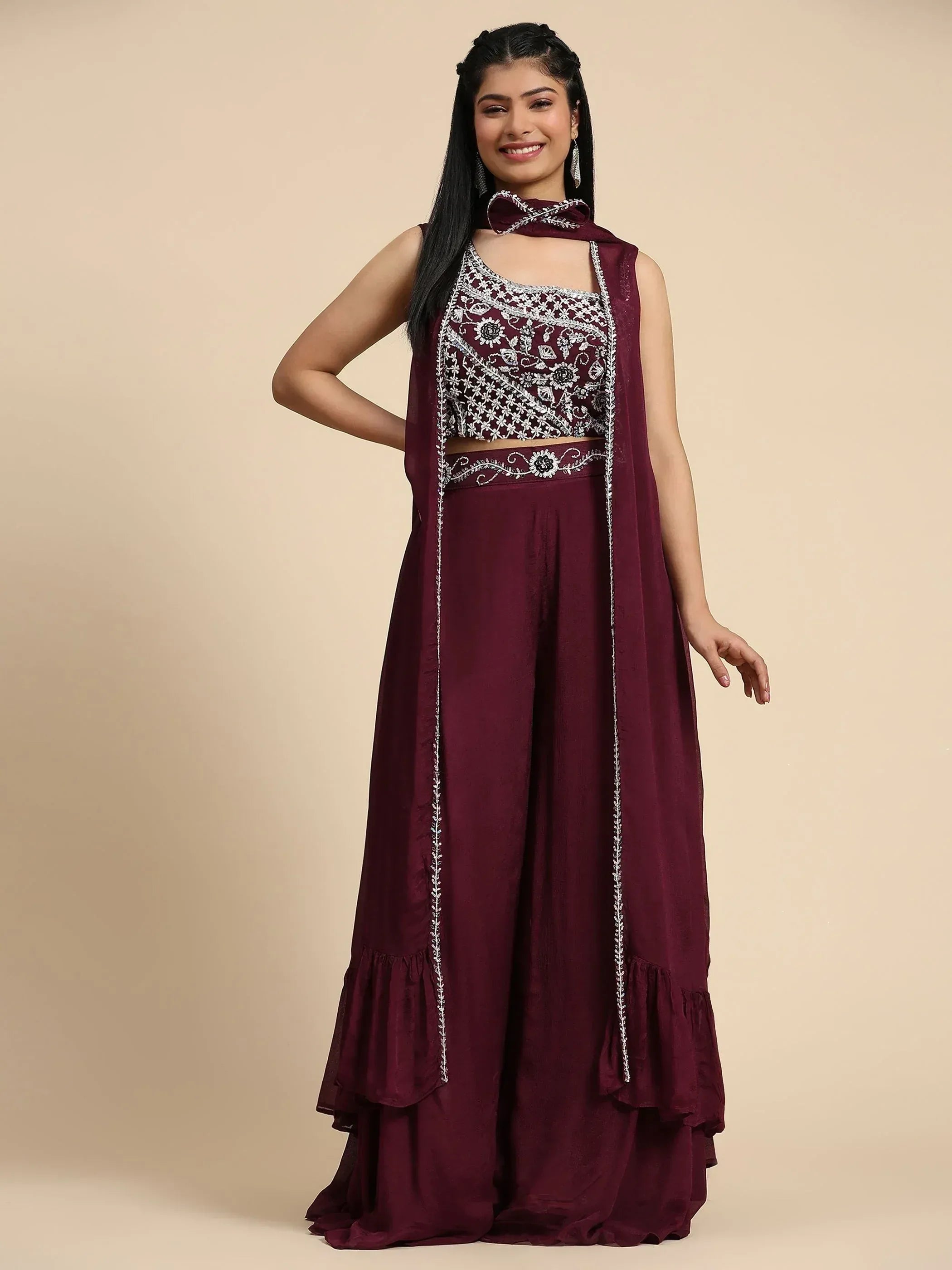 Maroon ethnic gown with floral embroidery and ruffled hem, perfect for Indian celebrations