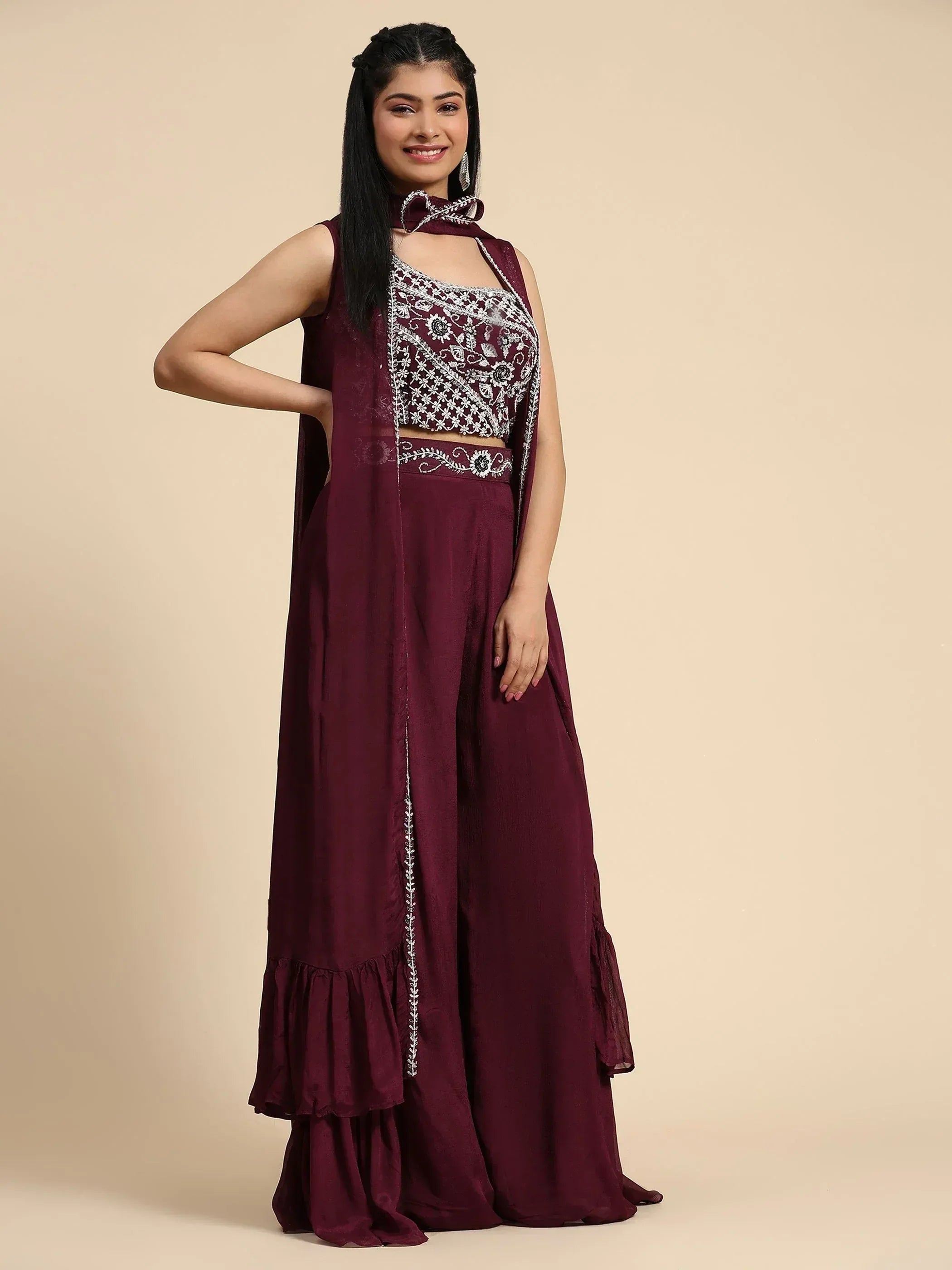 Maroon ethnic gown with white embroidery and ruffled hem, perfect for Indian celebrations