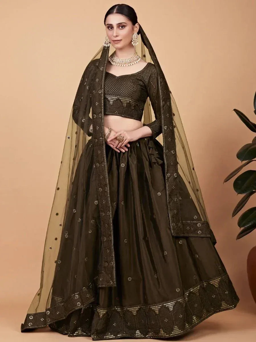 Olive green designer lehenga choli with mirror work and sheer dupatta, perfect for weddings and festivals.