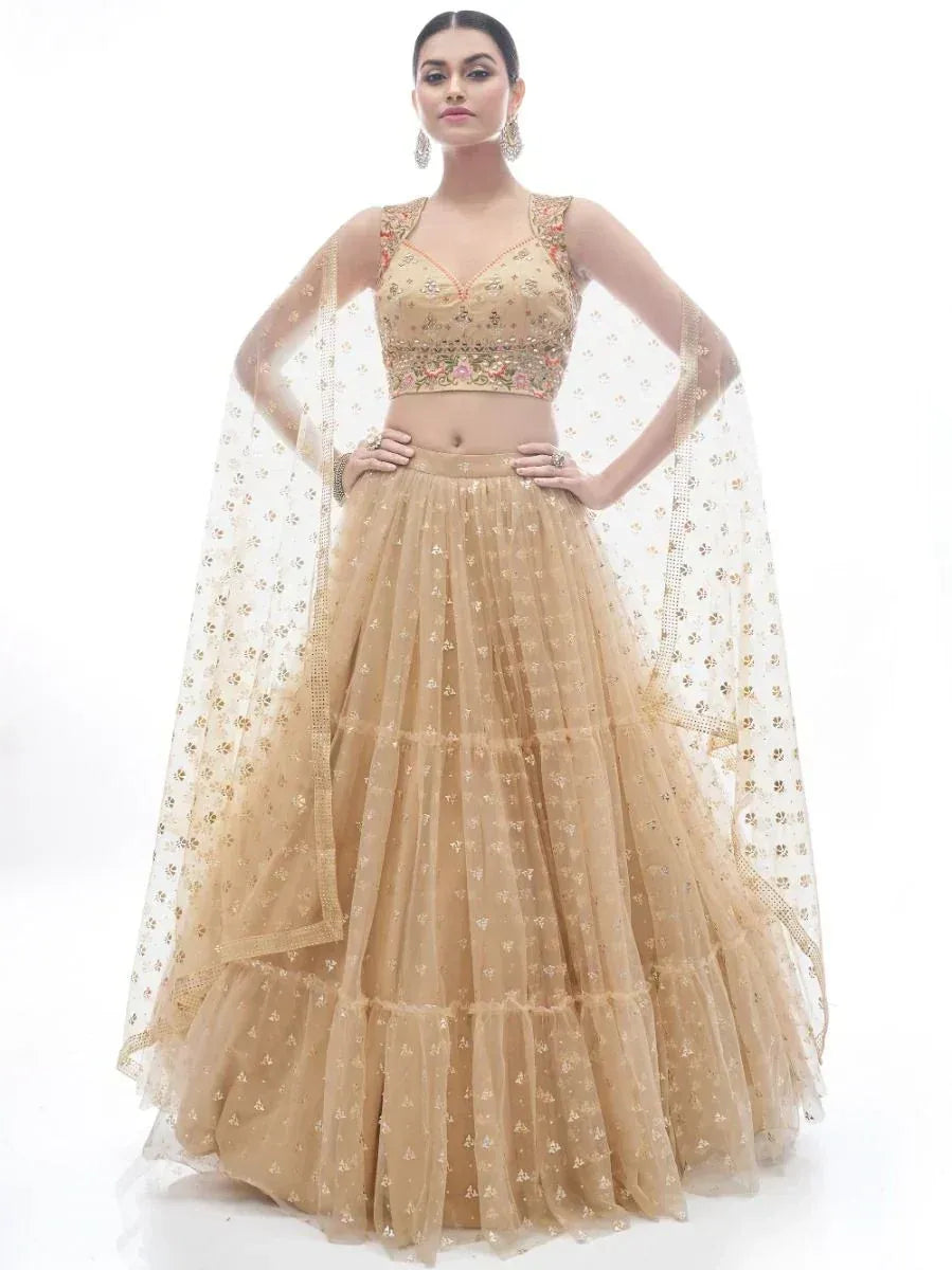 Beige embroidered lehenga choli with floral motifs and sheer dupatta, ideal for Indian ethnic occasions