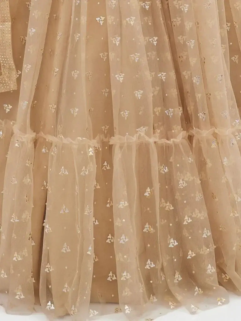 Attractive Beige Ruffle Work Net Lehenga With Embroidered Choli